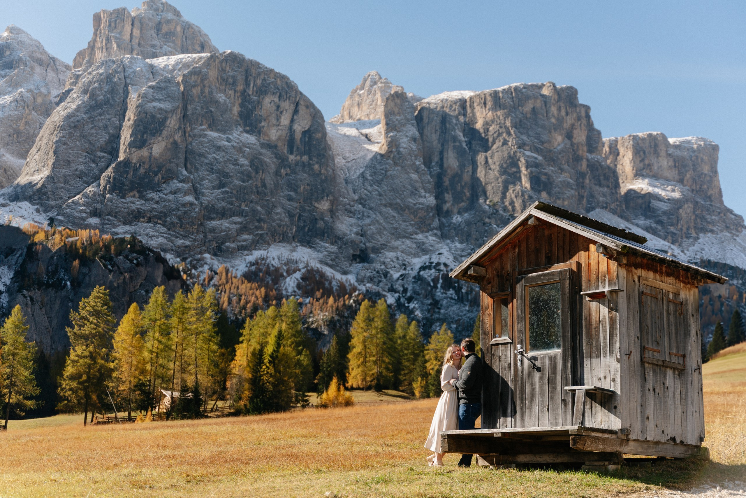 A quiet embrace beside a traditional wooden hut in Alta Badia, Dolomites