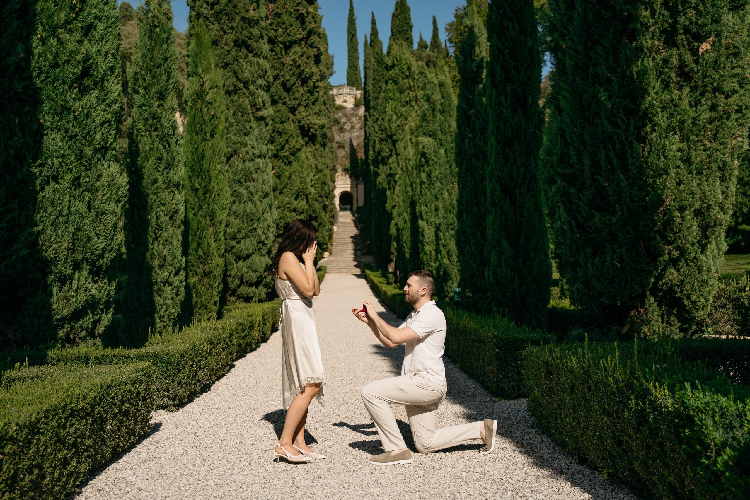 One partner kneeling to propose in the gardens of Giardino Giusti, Verona.