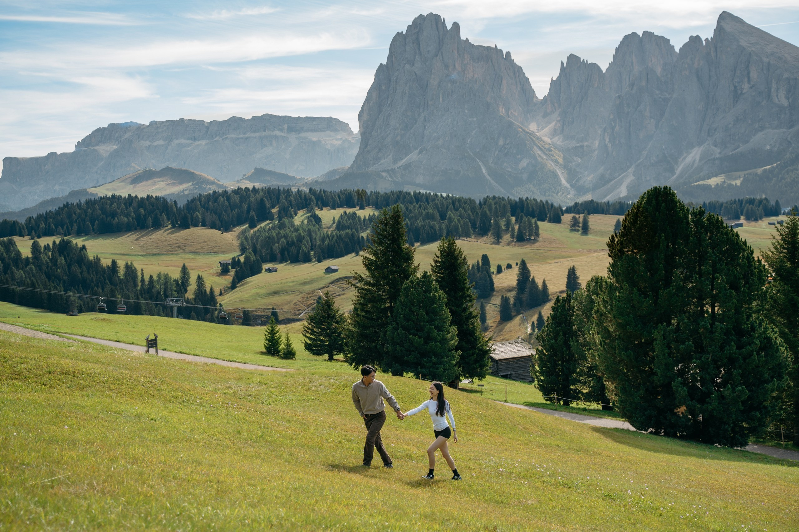 A panoramic photograph of a morning marriage proposal in the open landscape of Alpe di Siusi.