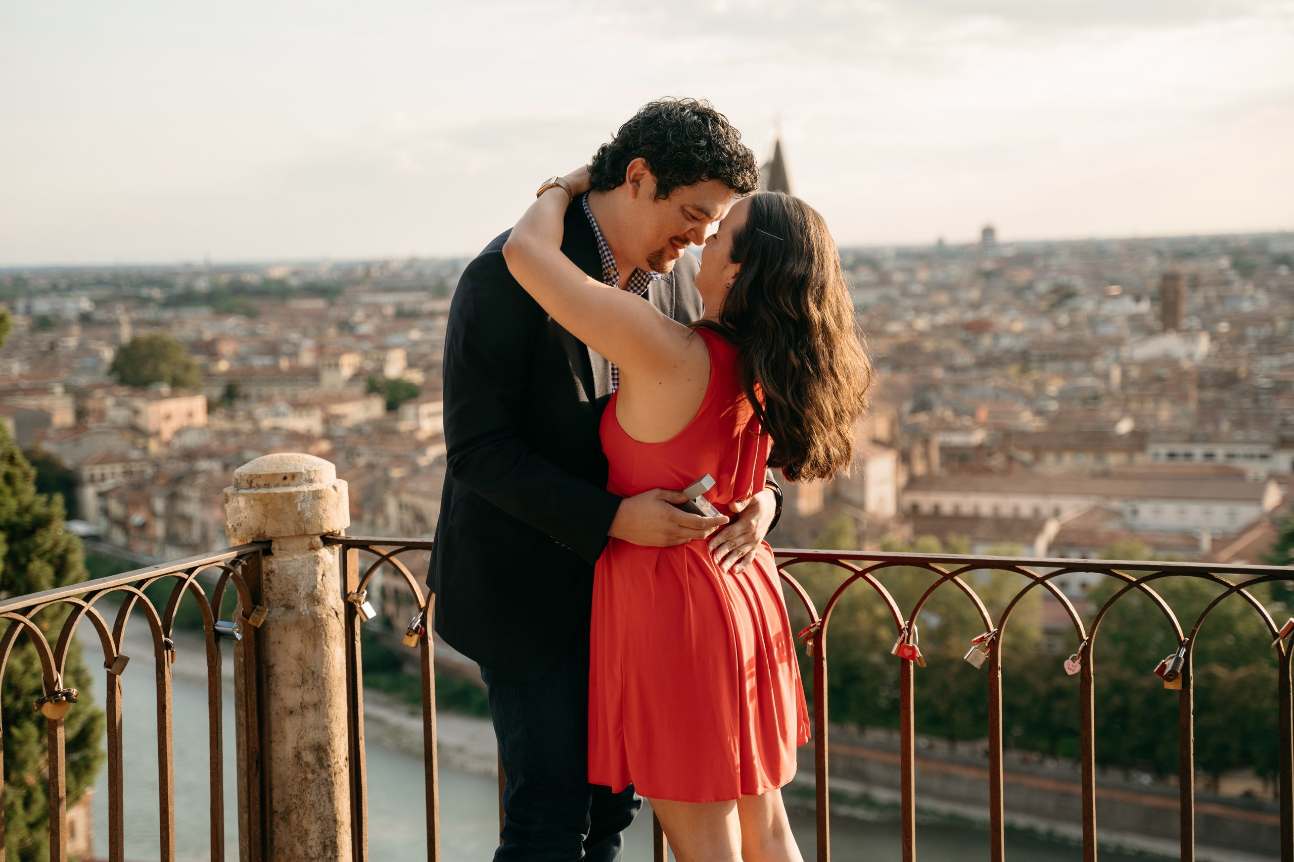A couple getting engaged at Castel San Pietro with sunset views over Verona.