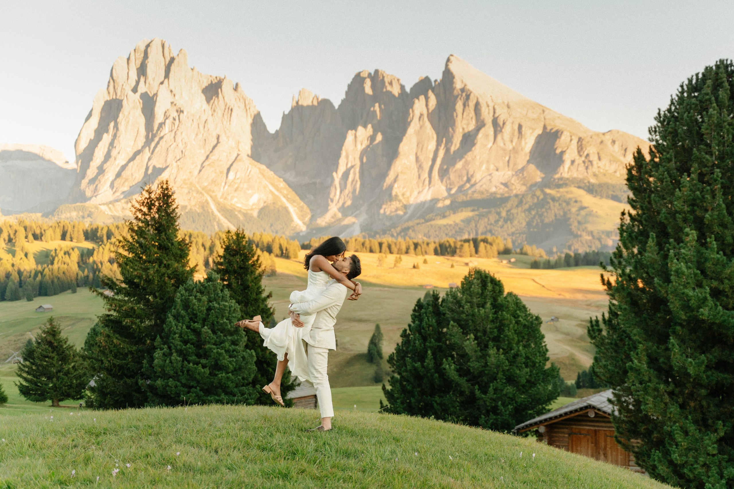 A couple embracing moments after their proposal near Alpe Lodge.