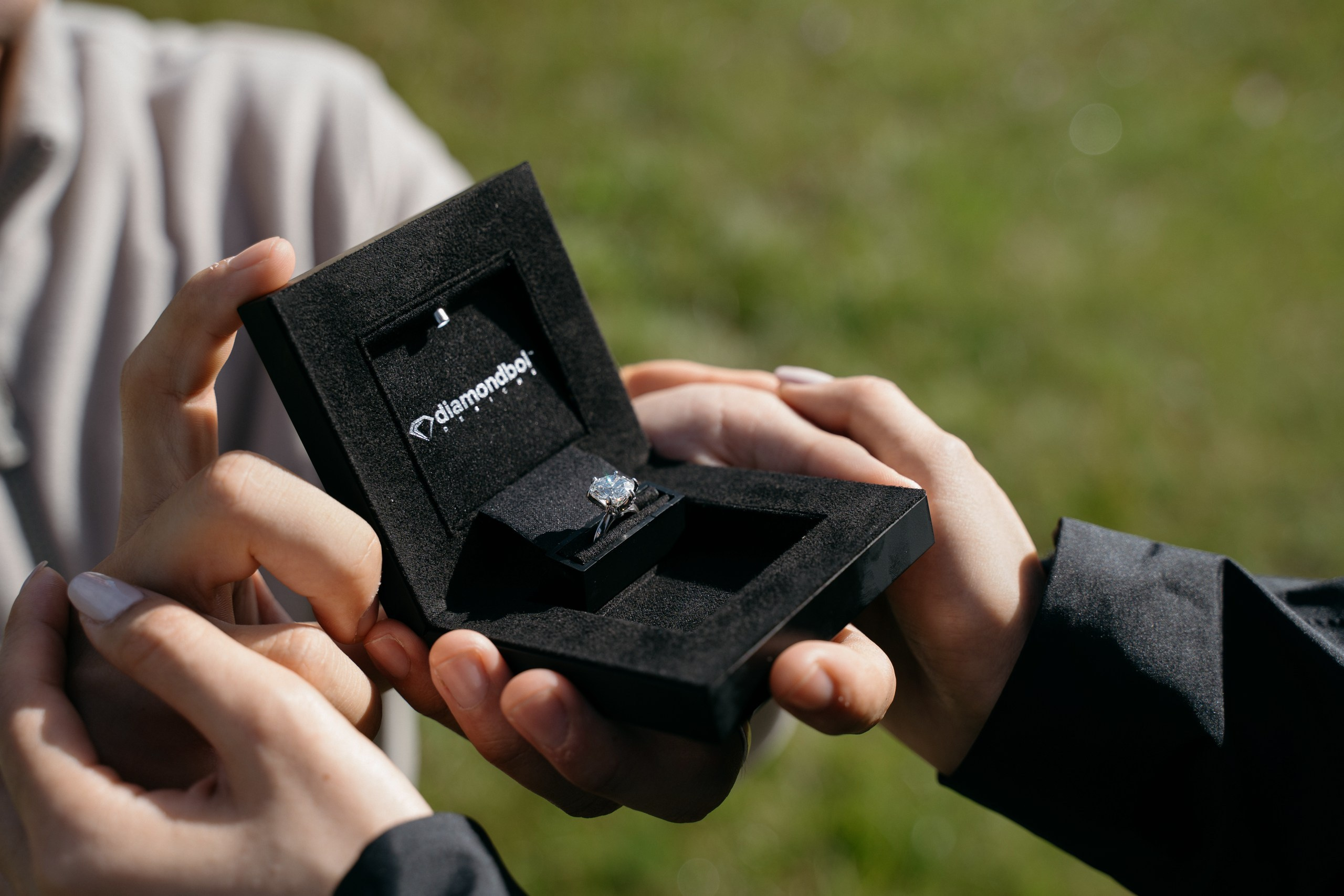 An engagement ring offered during a surprise proposal on Alpe di Siusi in the morning light.