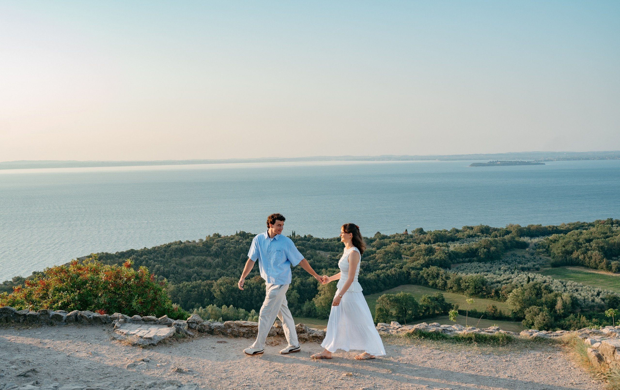 Newly engaged couple enjoying the lake views from Rocca di Manerba in the morning light.