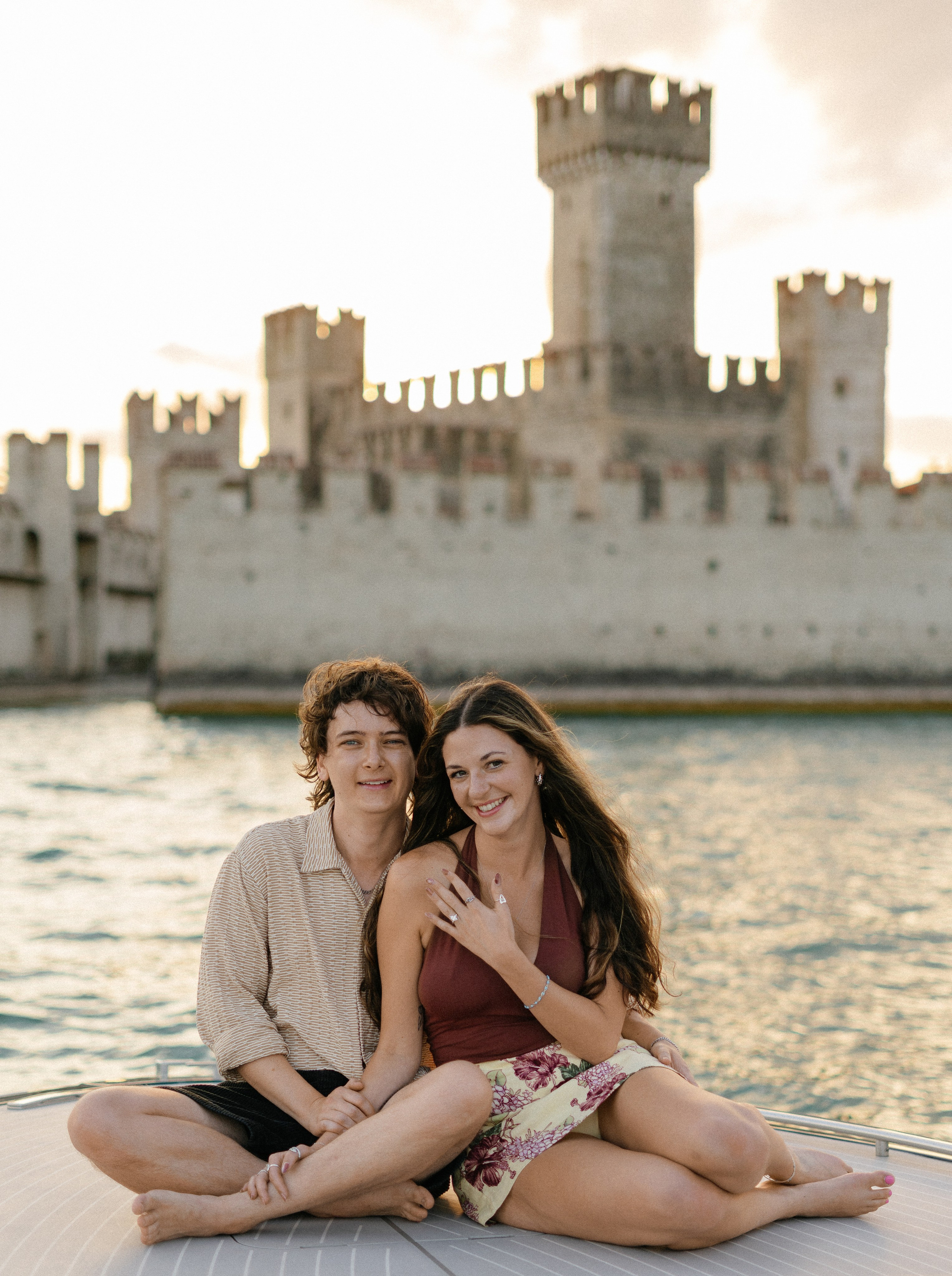 Newly engaged couple celebrating their luxury boat proposal in Sirmione on Lake Garda.