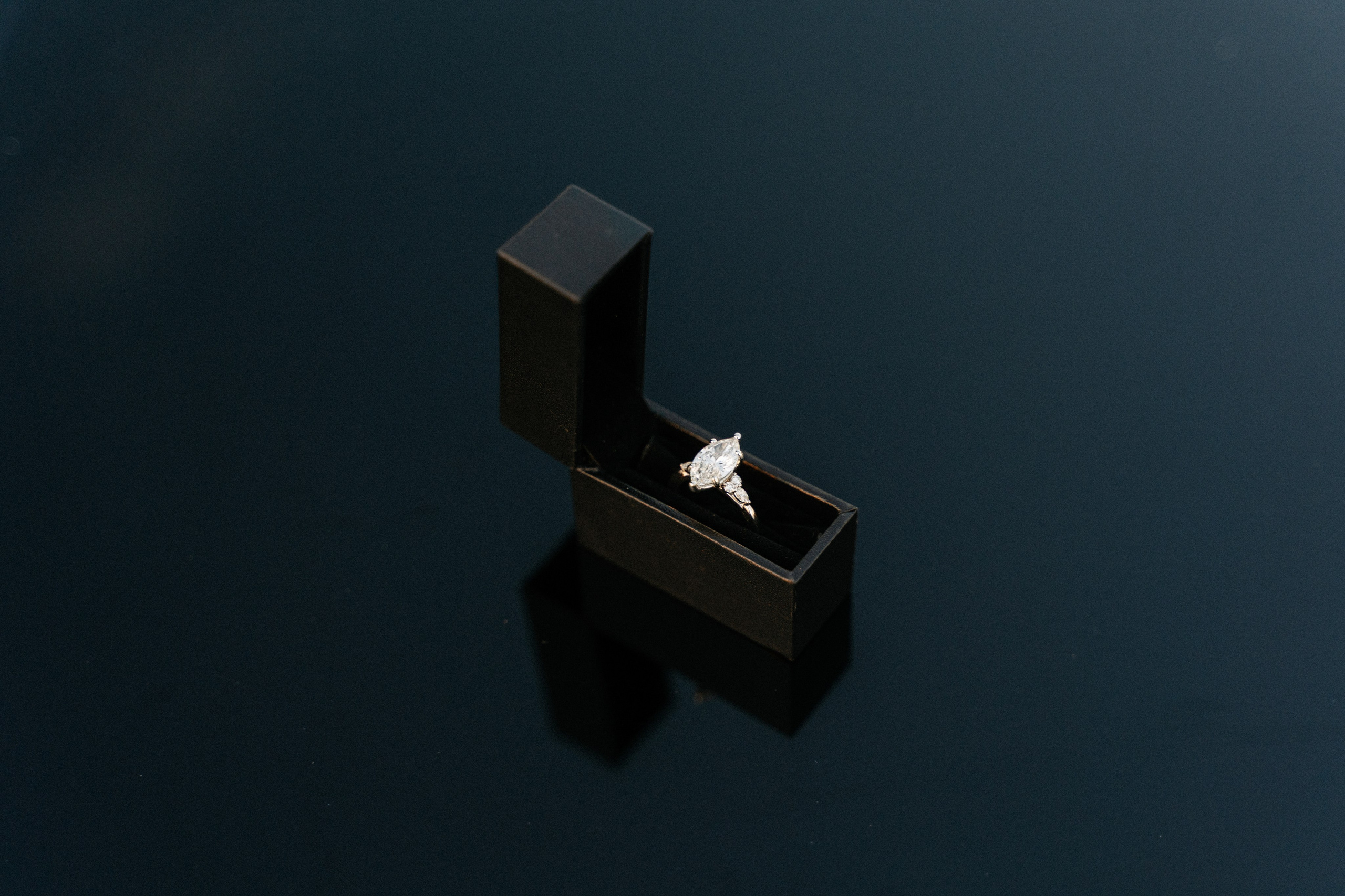 Engagement ring photographed aboard an elegant boat during a sunset proposal in Sirmione.