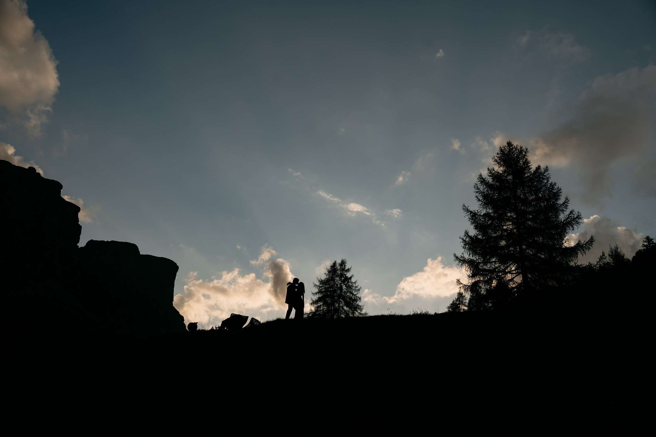 Newly engaged couple together against the dramatic peaks of the Dolomites.