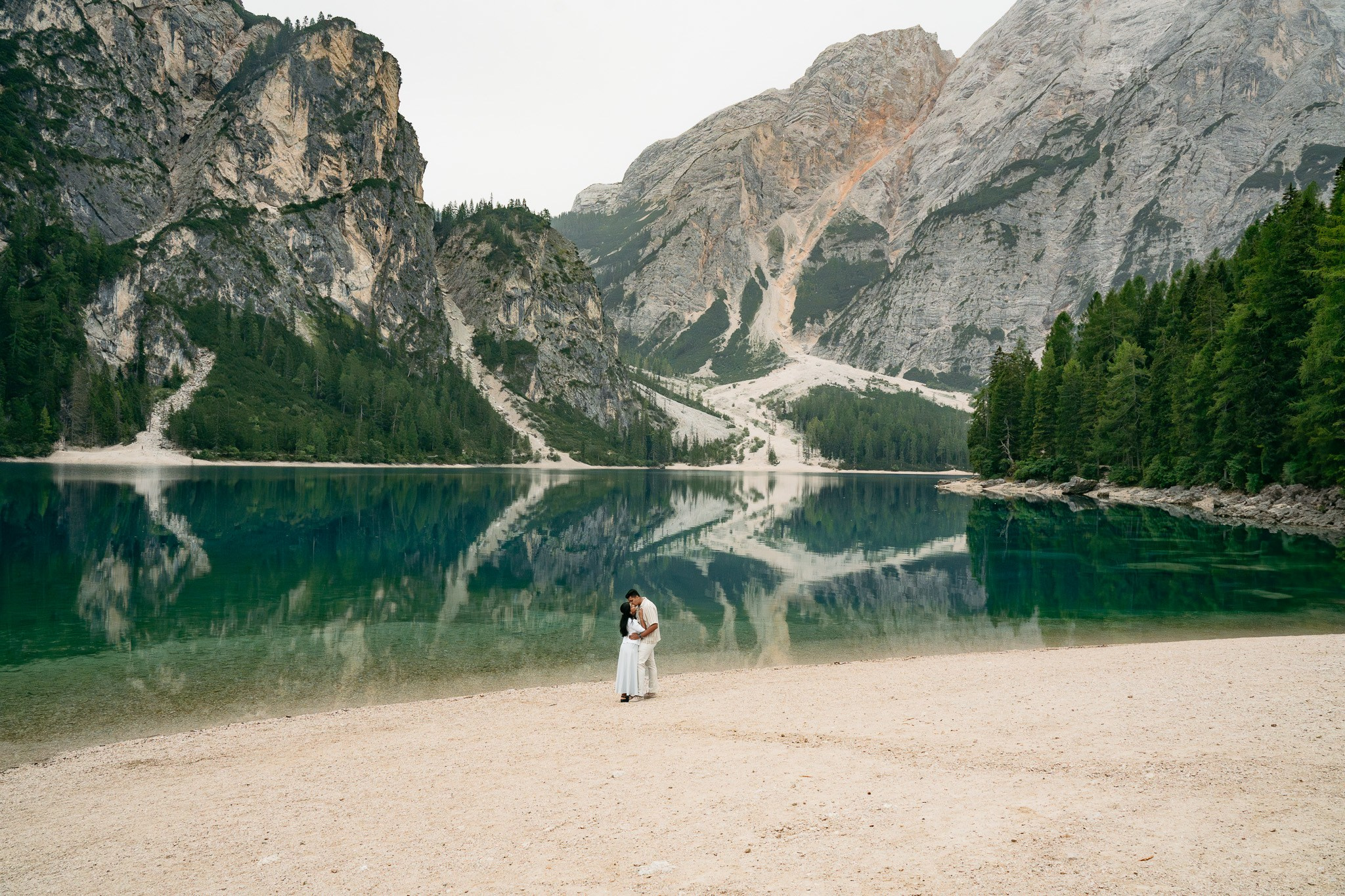Destination marriage proposal at Lake Braies in the quiet atmosphere of sunrise.