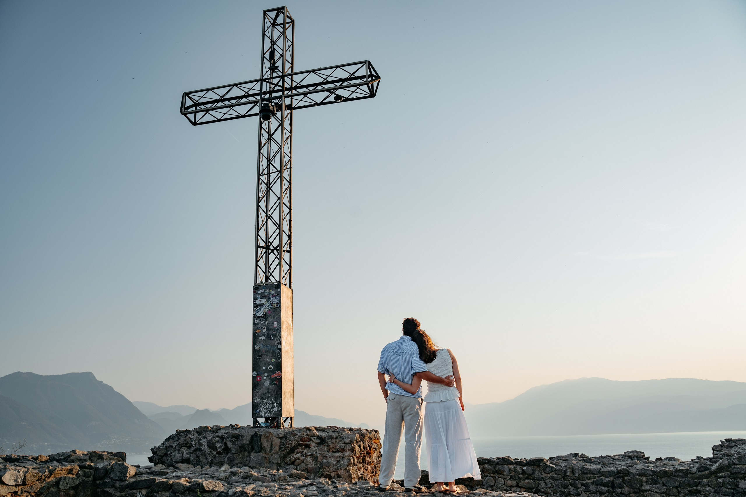 an intimate moment during an early morning proposal at Rocca di Manerba, Lake Garda.
