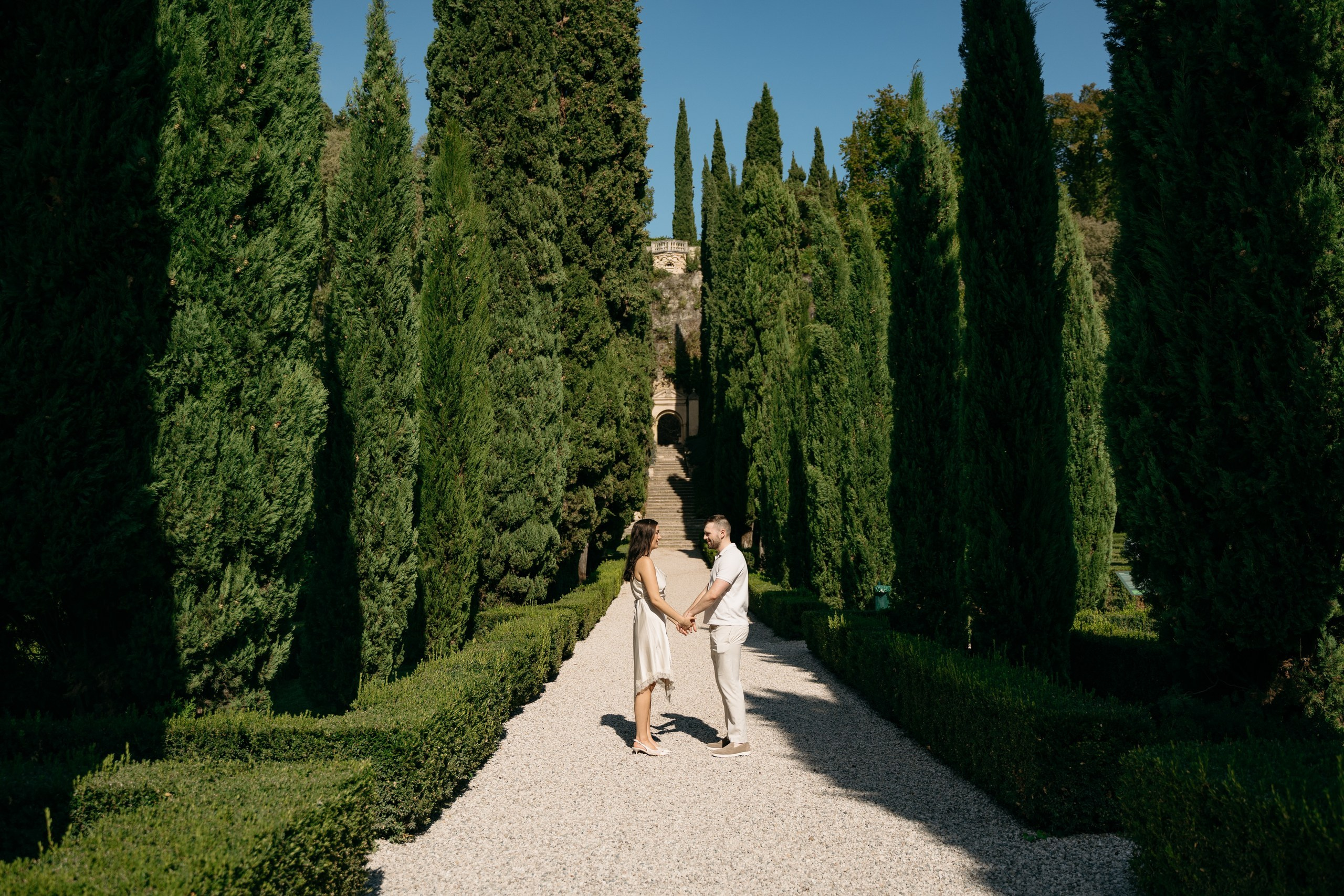 A wide view of a marriage proposal surrounded by greenery at Giardino Giusti, Verona.