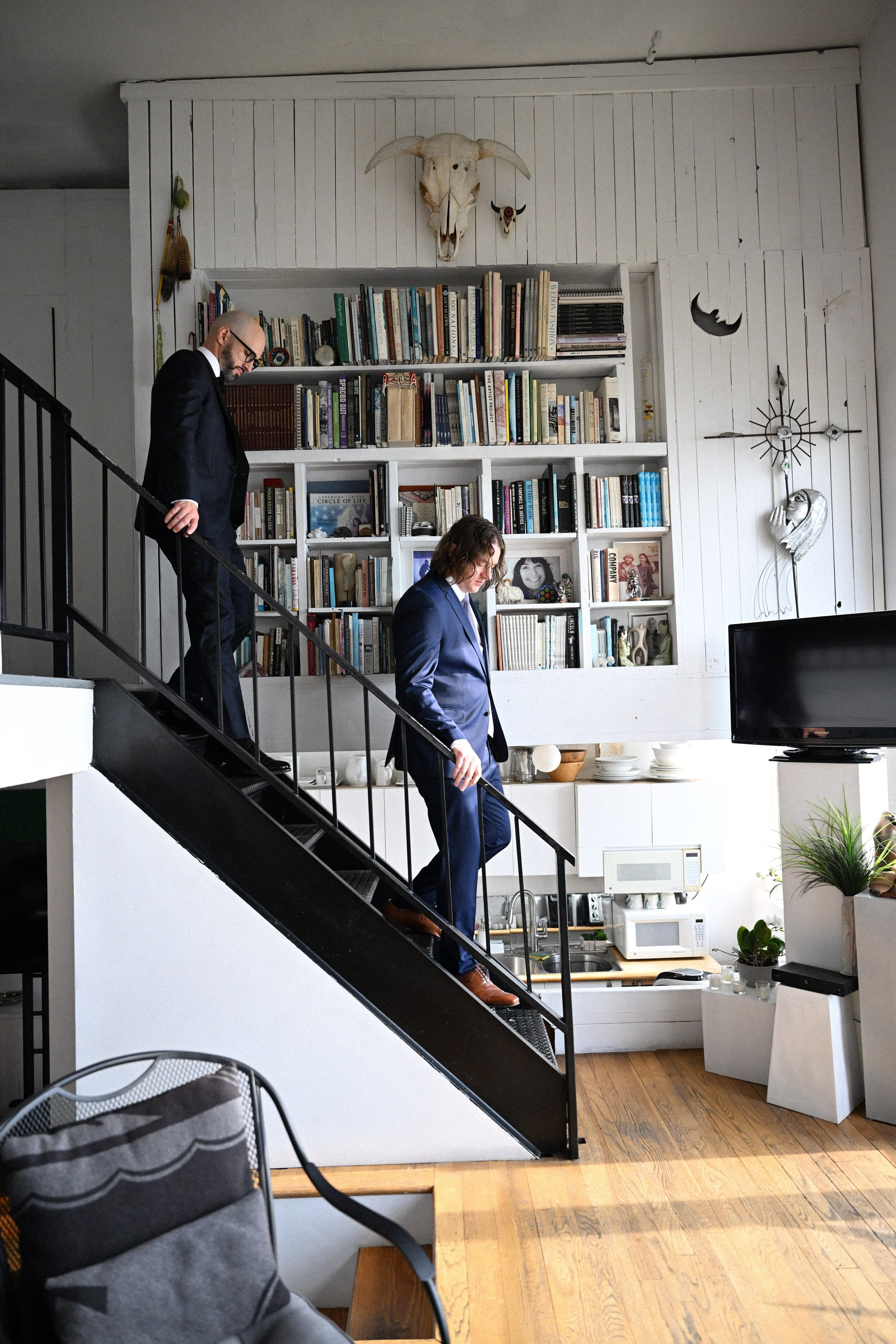 a man in a suit is walking up a set of stairs