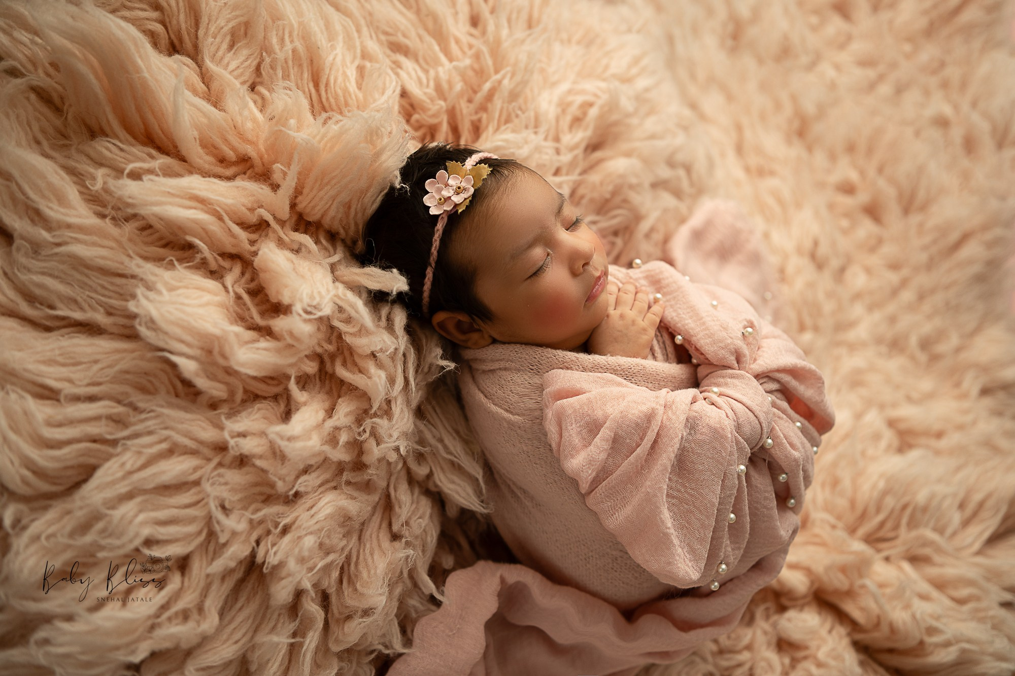 pastel pink flokati fur as a background for little infant.