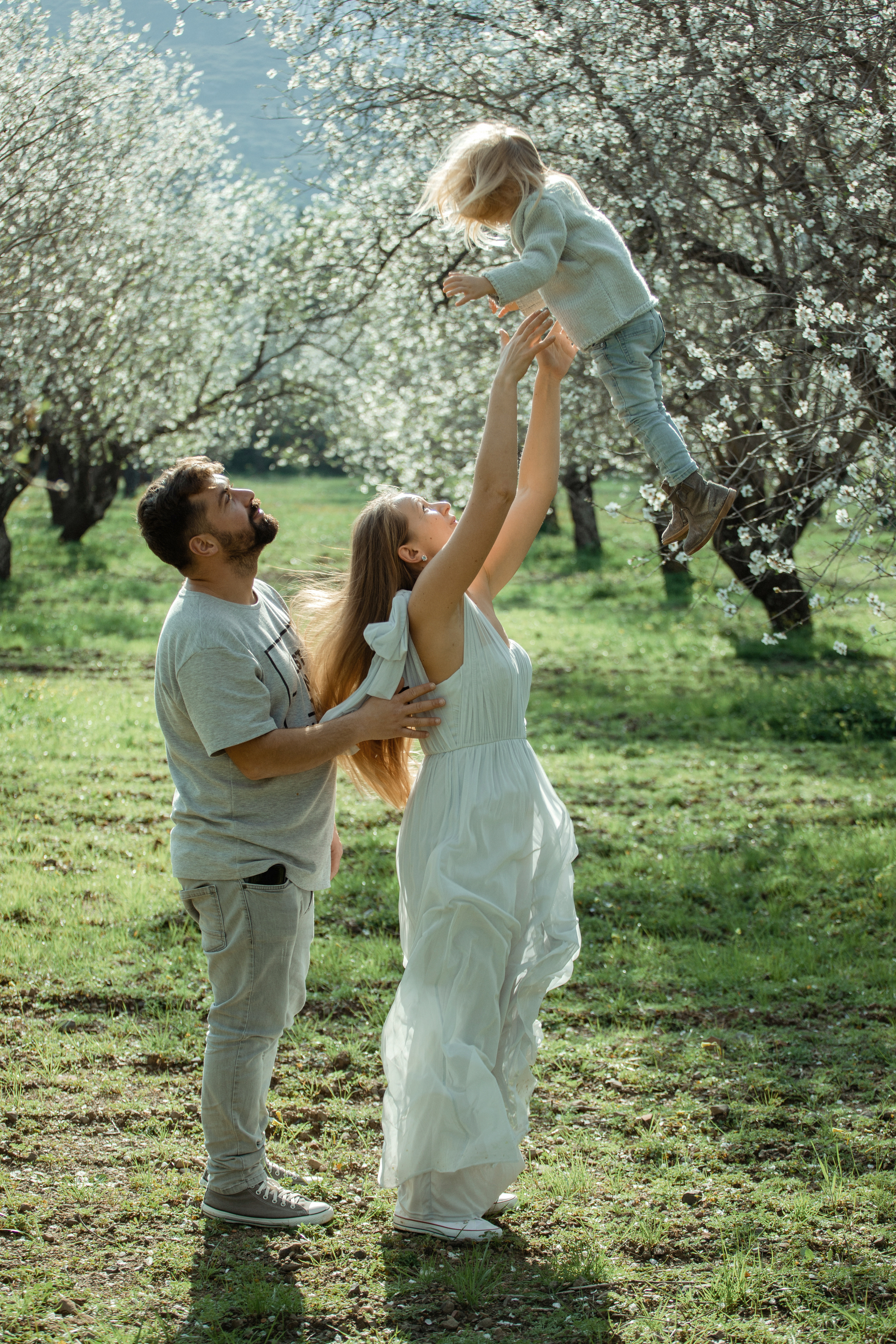 Family photo session in a flowering almond garden. Julia Ganch I Fashion Wedding Photography I Cappadocia Turkey