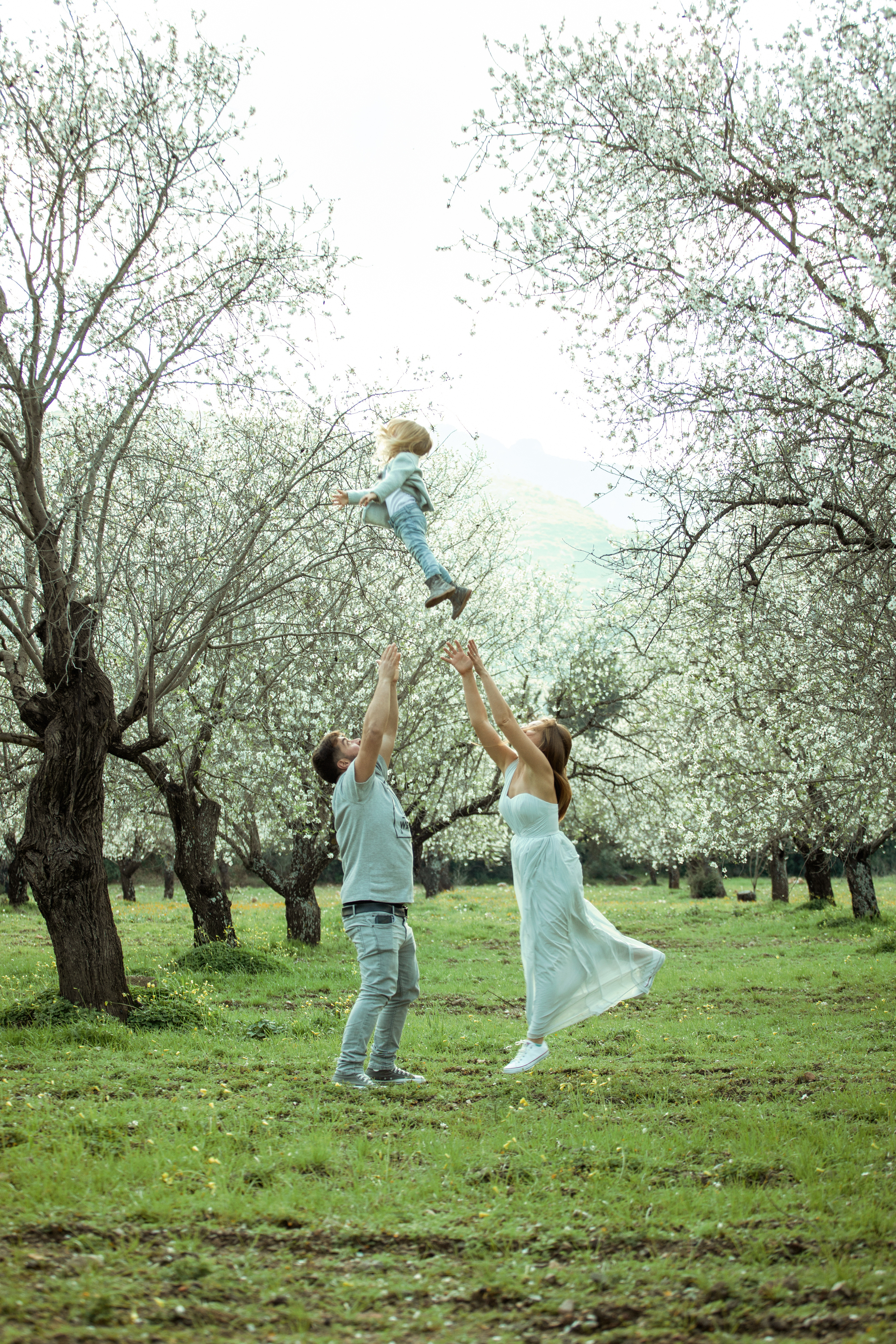 Family photo session in a flowering almond garden. Julia Ganch I Fashion Wedding Photography I Cappadocia Turkey