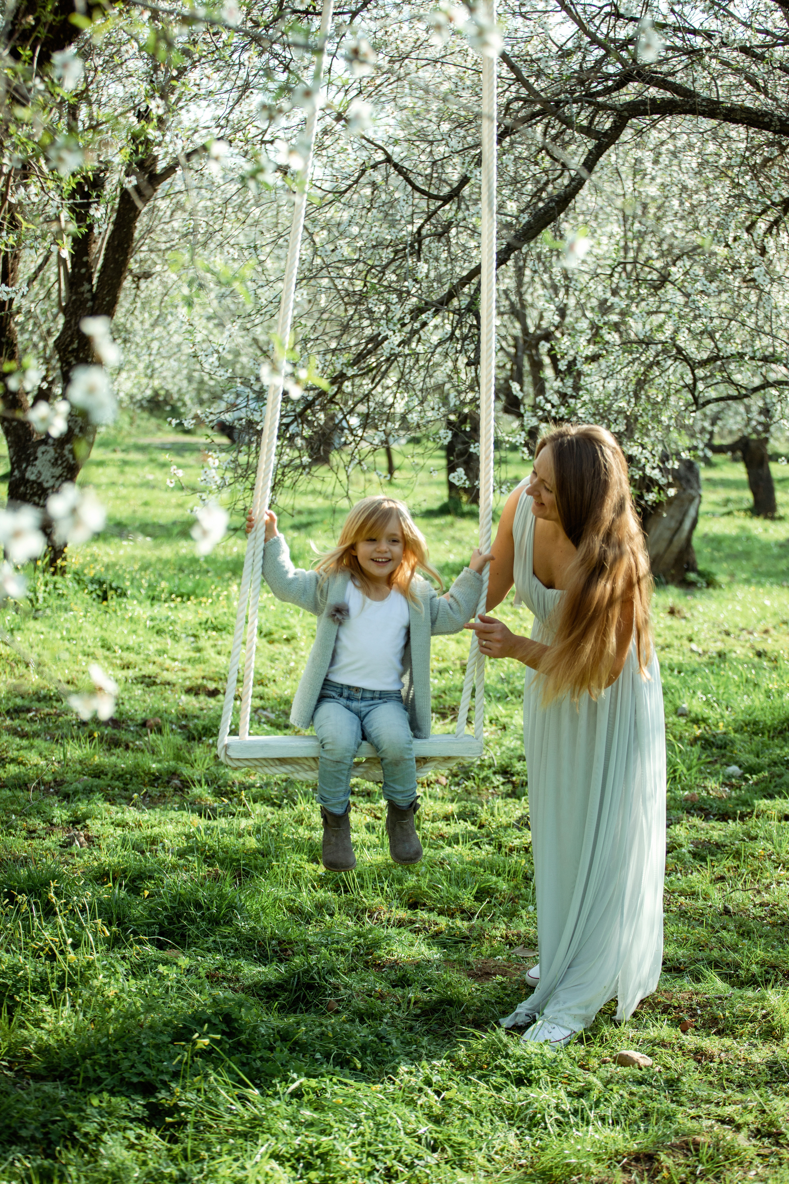 Family photo session in a flowering almond garden. Julia Ganch I Fashion Wedding Photography I Cappadocia Turkey