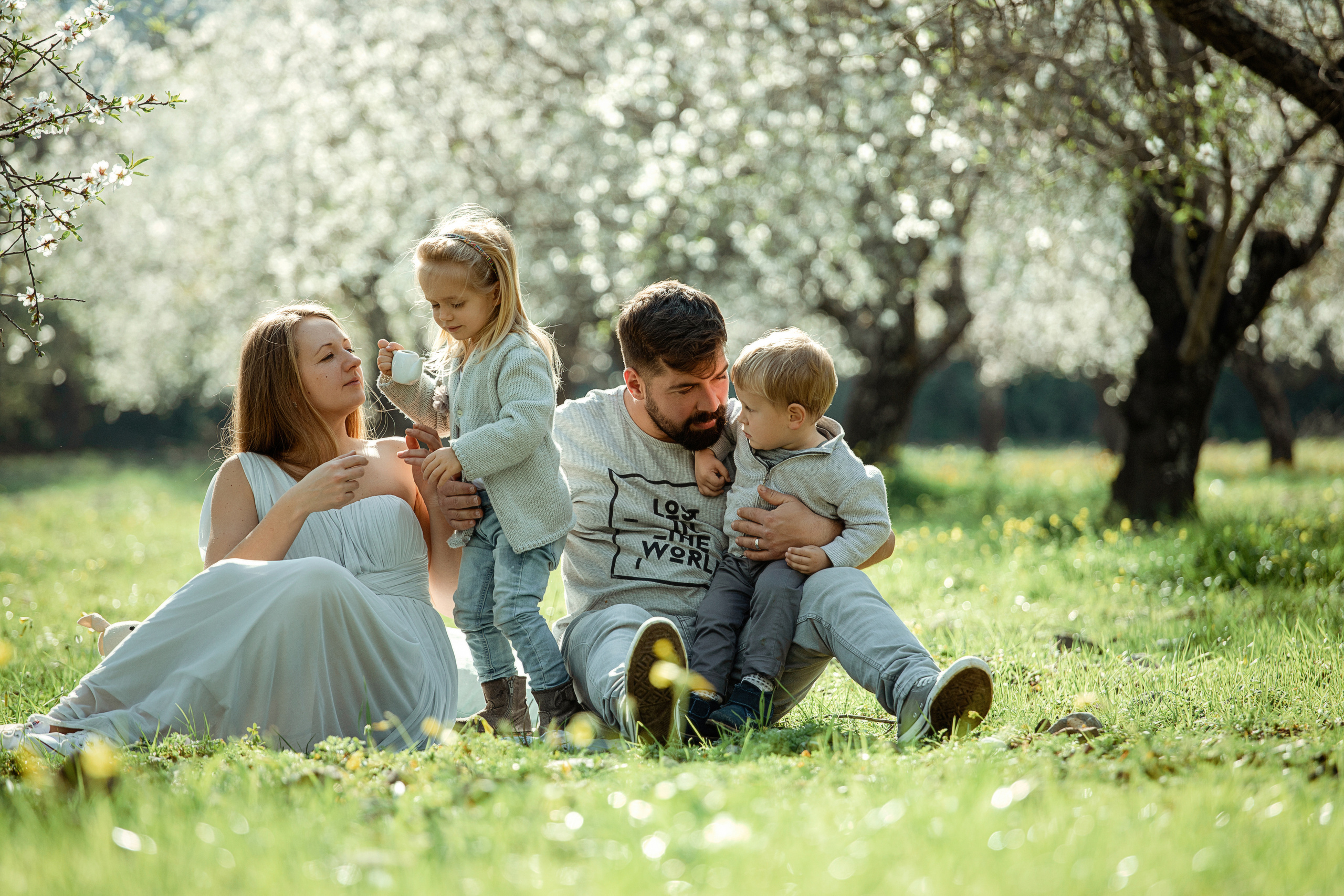 Family photo session in a flowering almond garden. Julia Ganch I Fashion Wedding Photography I Cappadocia Turkey