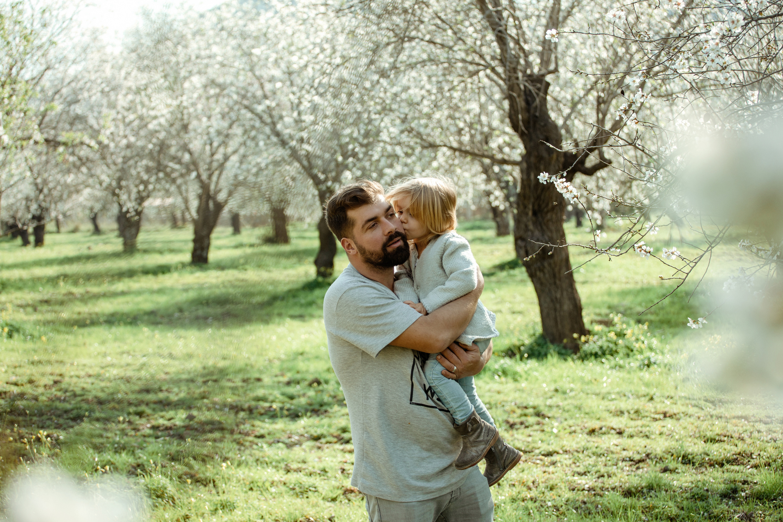 Family photo session in a flowering almond garden. Julia Ganch I Fashion Wedding Photography I Cappadocia Turkey