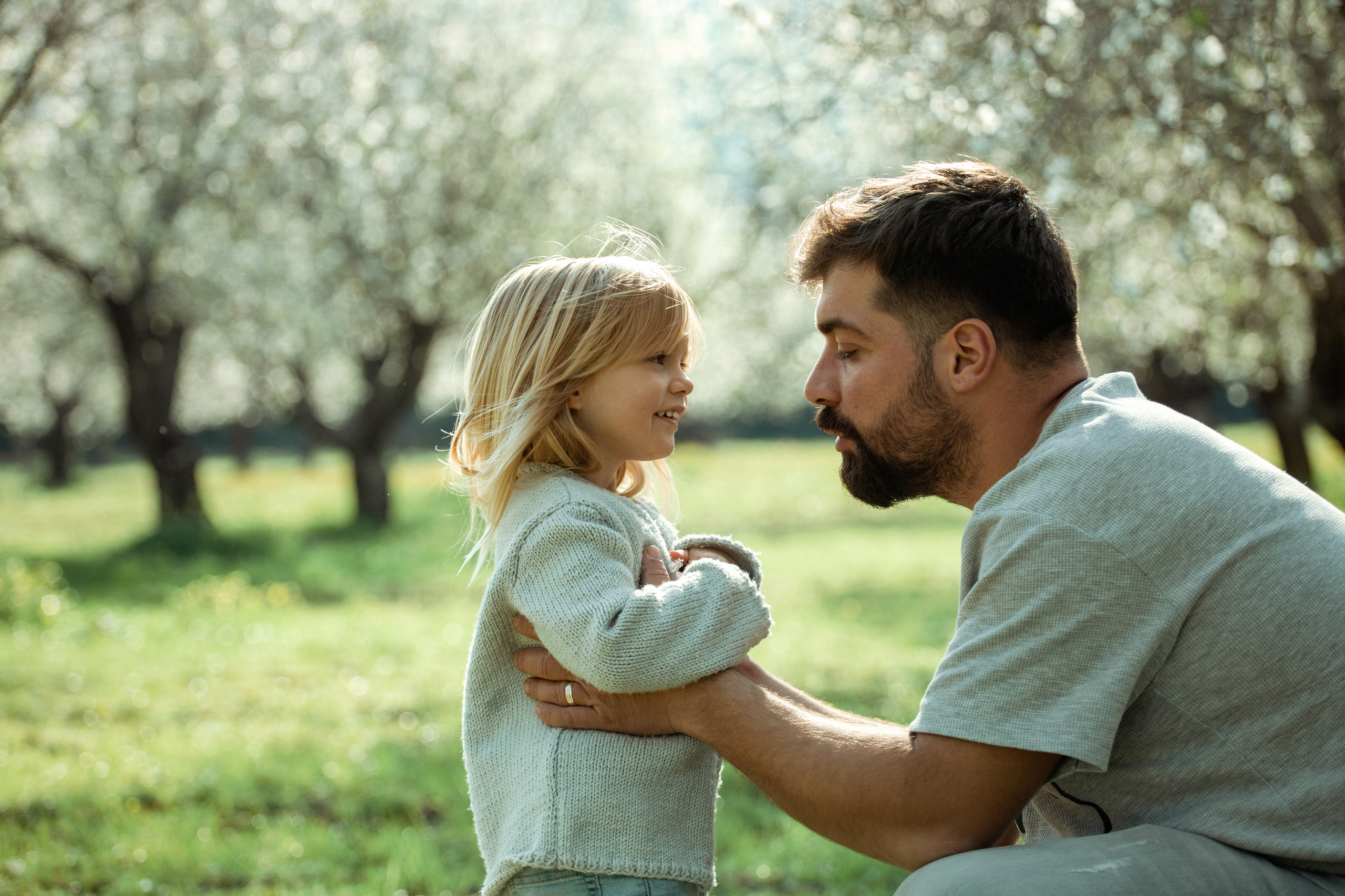 Family photo session in a flowering almond garden. Julia Ganch I Fashion Wedding Photography I Cappadocia Turkey