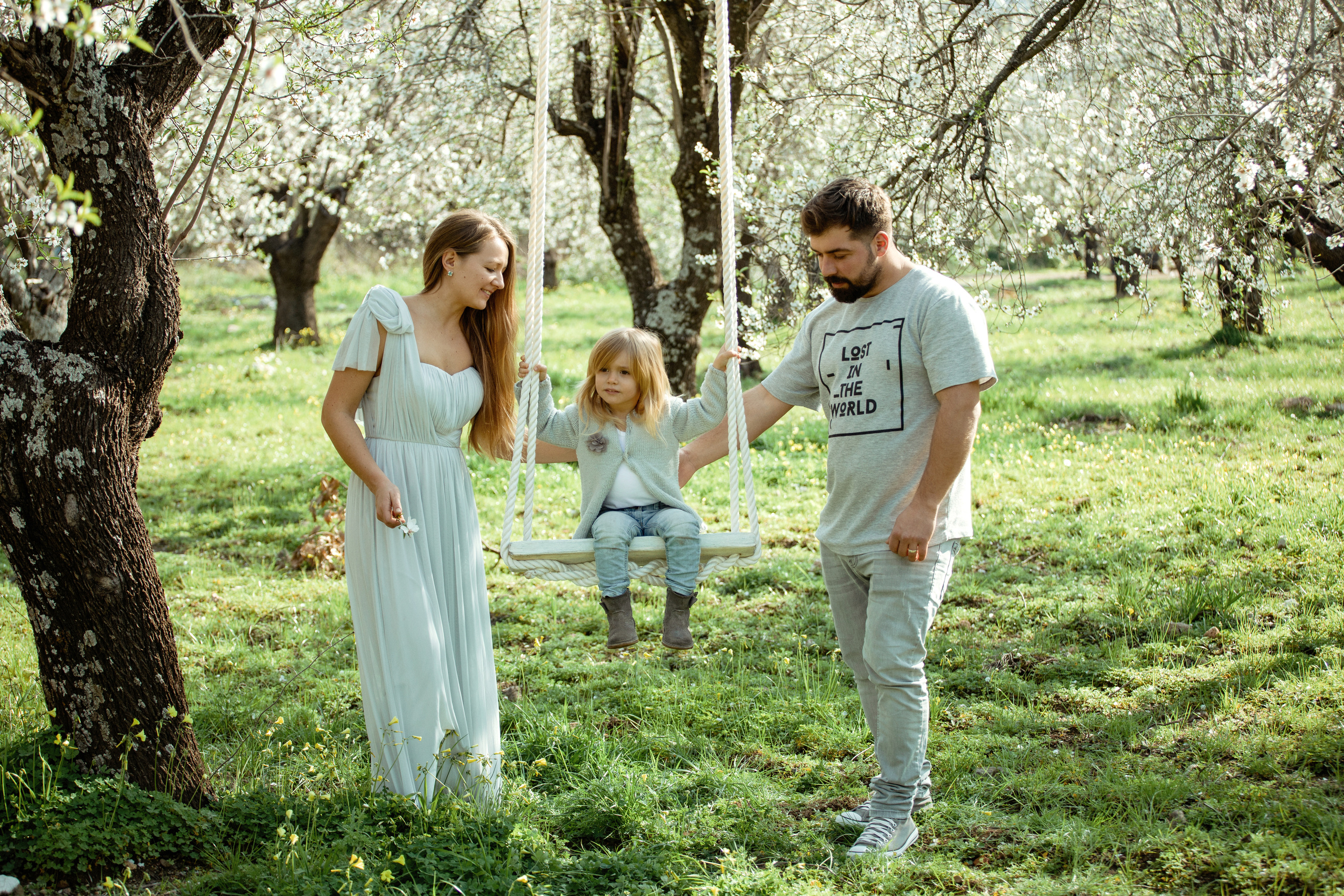 Family photo session in a flowering almond garden. Julia Ganch I Fashion Wedding Photography I Cappadocia Turkey