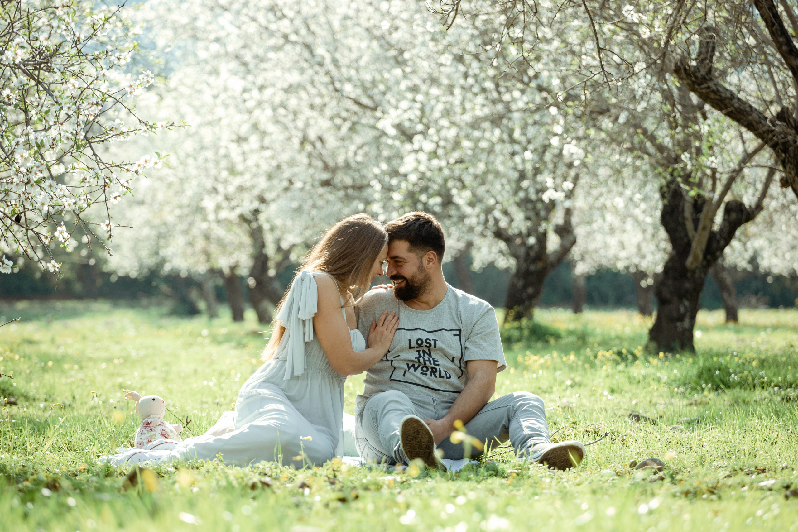 Family photo session in a flowering almond garden. Julia Ganch I Fashion Wedding Photography I Cappadocia Turkey