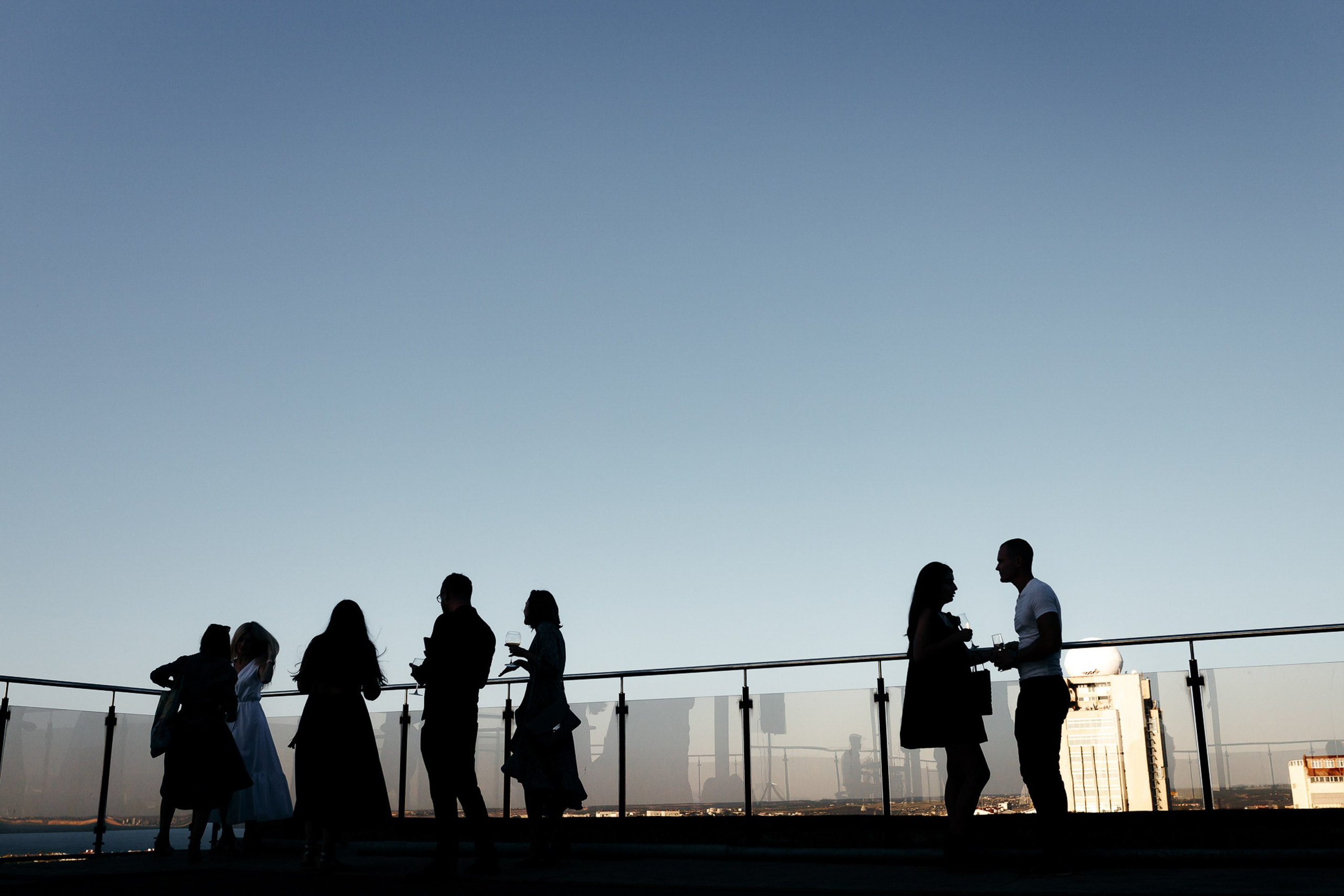 Silhouettes of people against sunset