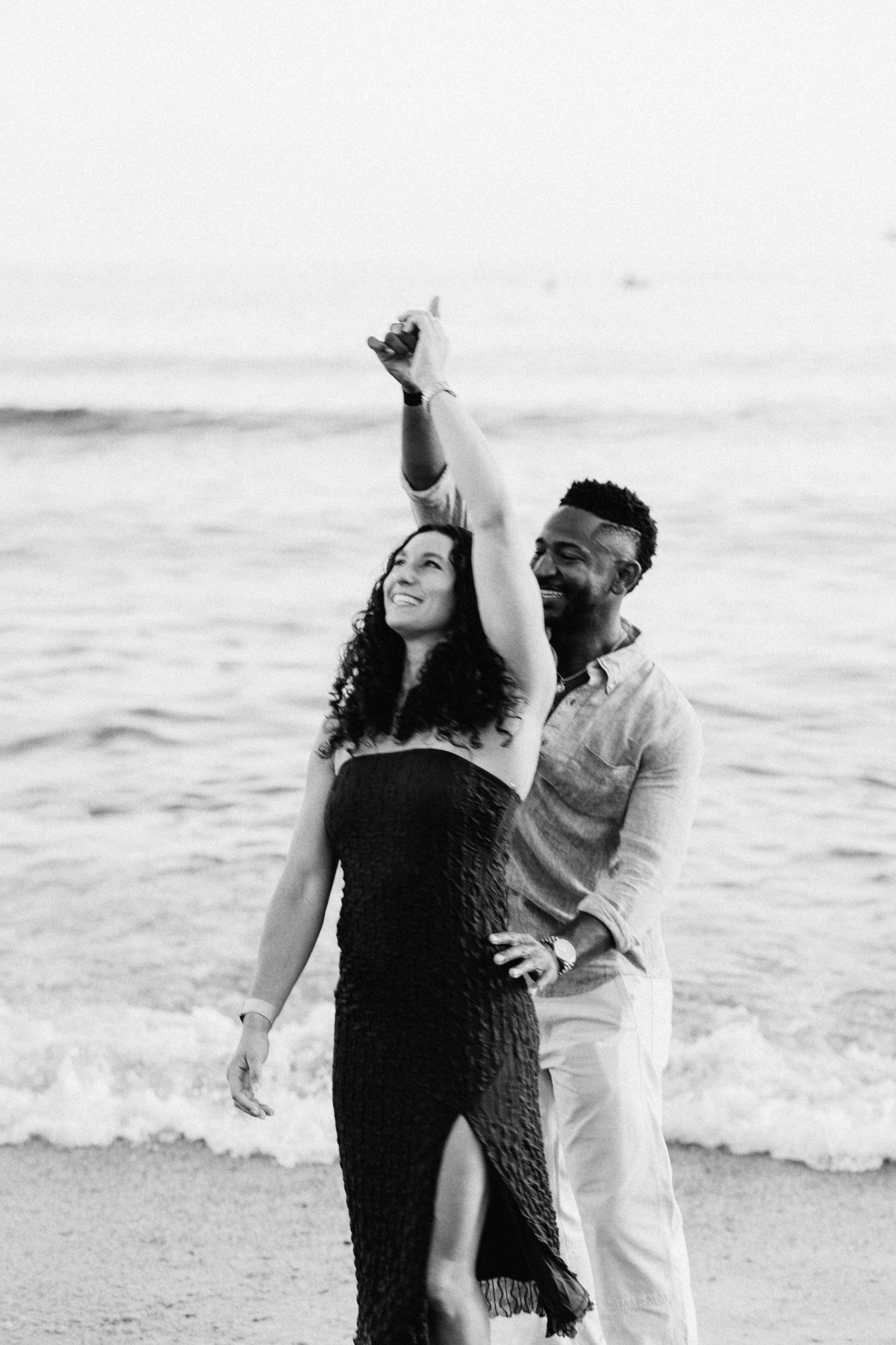 Joyful celebration after a surprise beach proposal in Málaga, Spain. Destination engagement photography capturing authentic emotion and movement by the Mediterranean shoreline.