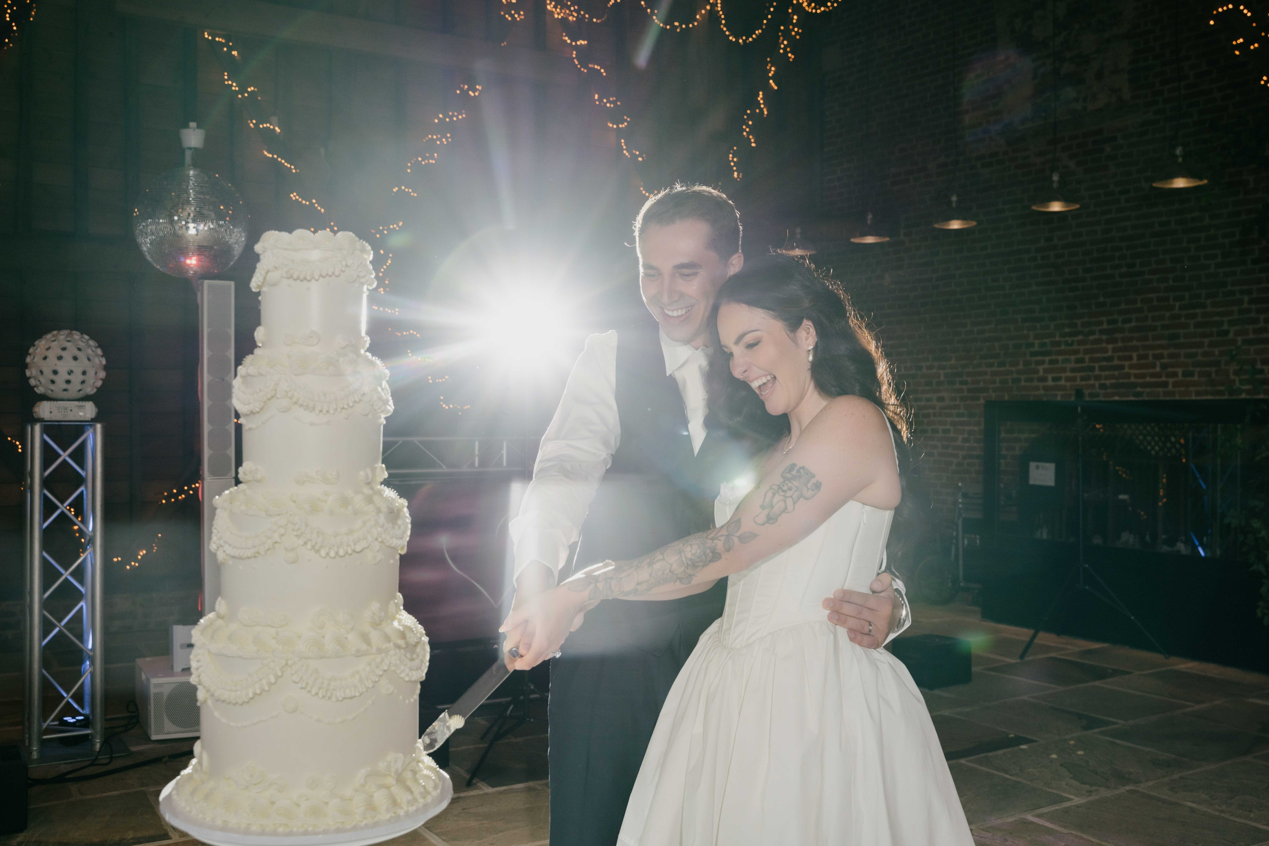     bride and groom cutting cake Essex wedding celebration