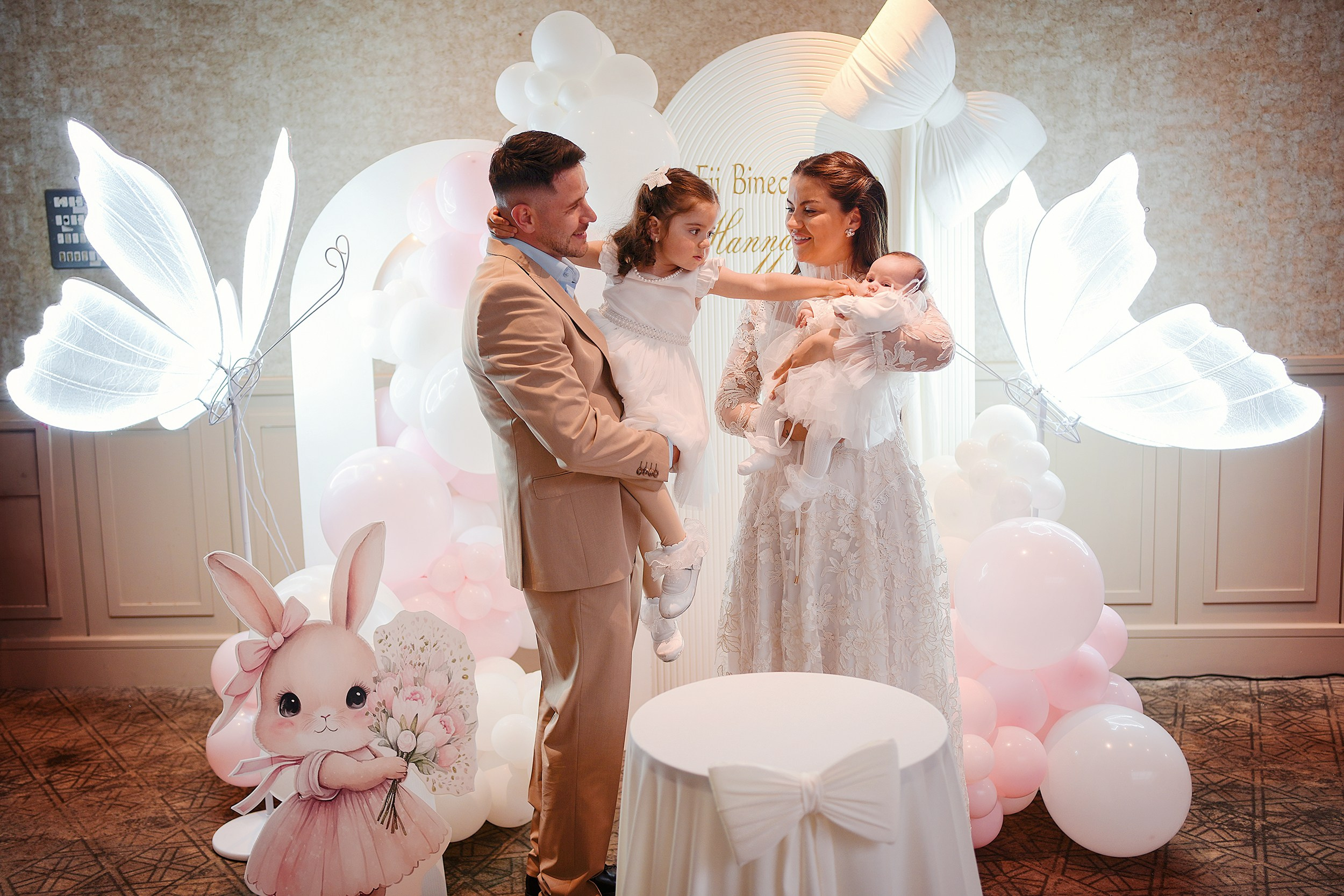 Wide shot of family at a christening setup.