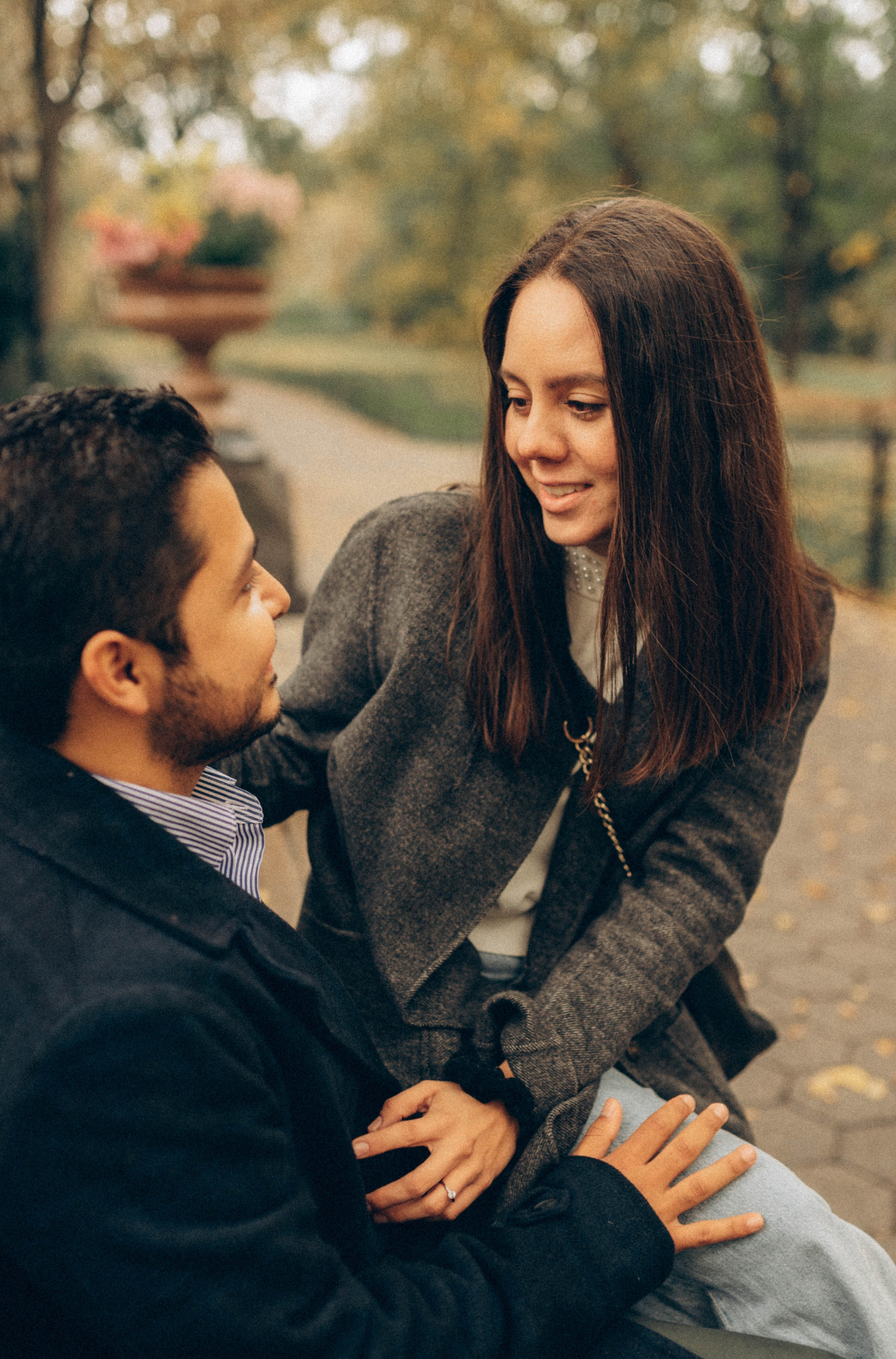 Couple embracing with Manhattan Bridge skyline.