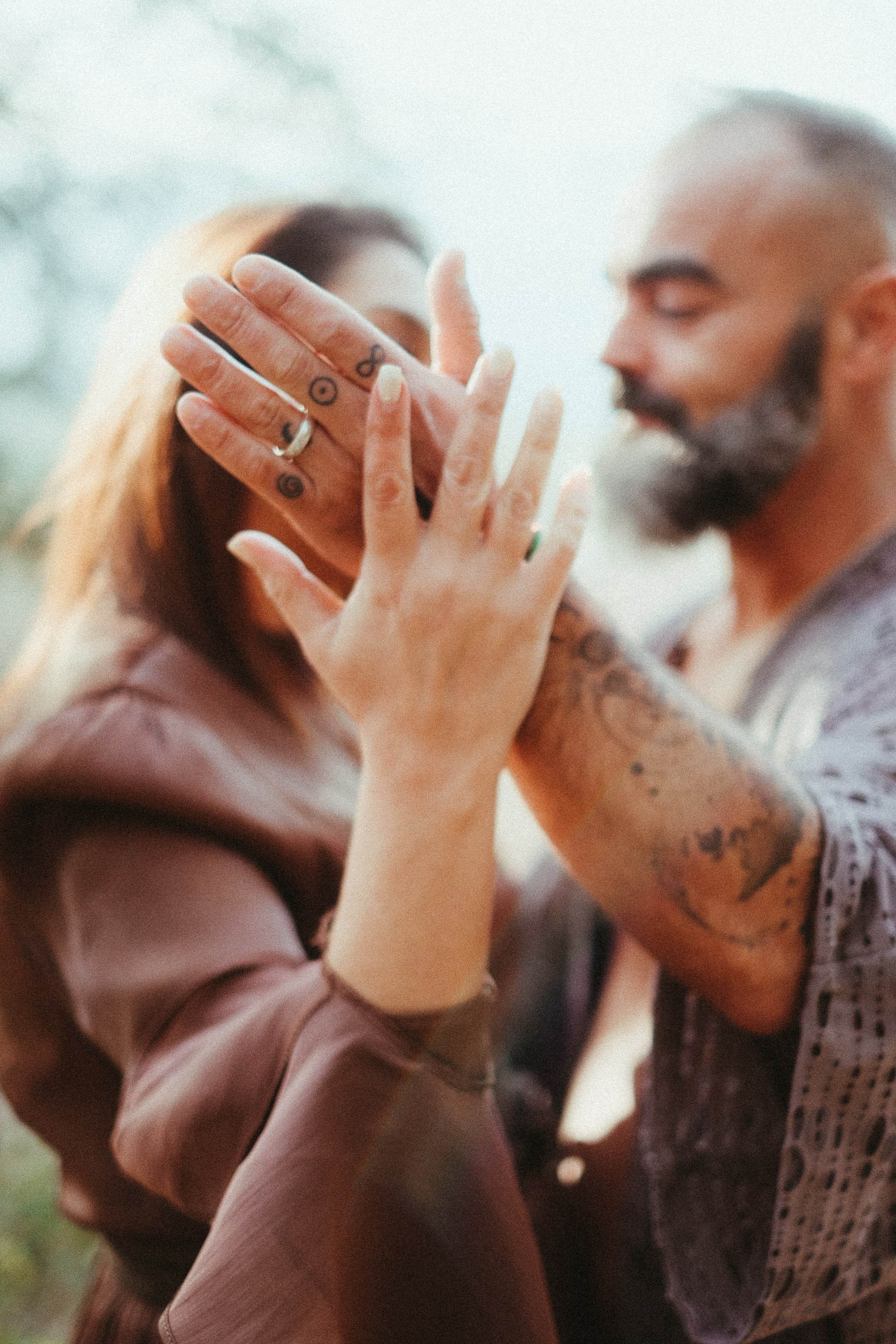 Couple on mossy rock during forest engagement session in Portugal