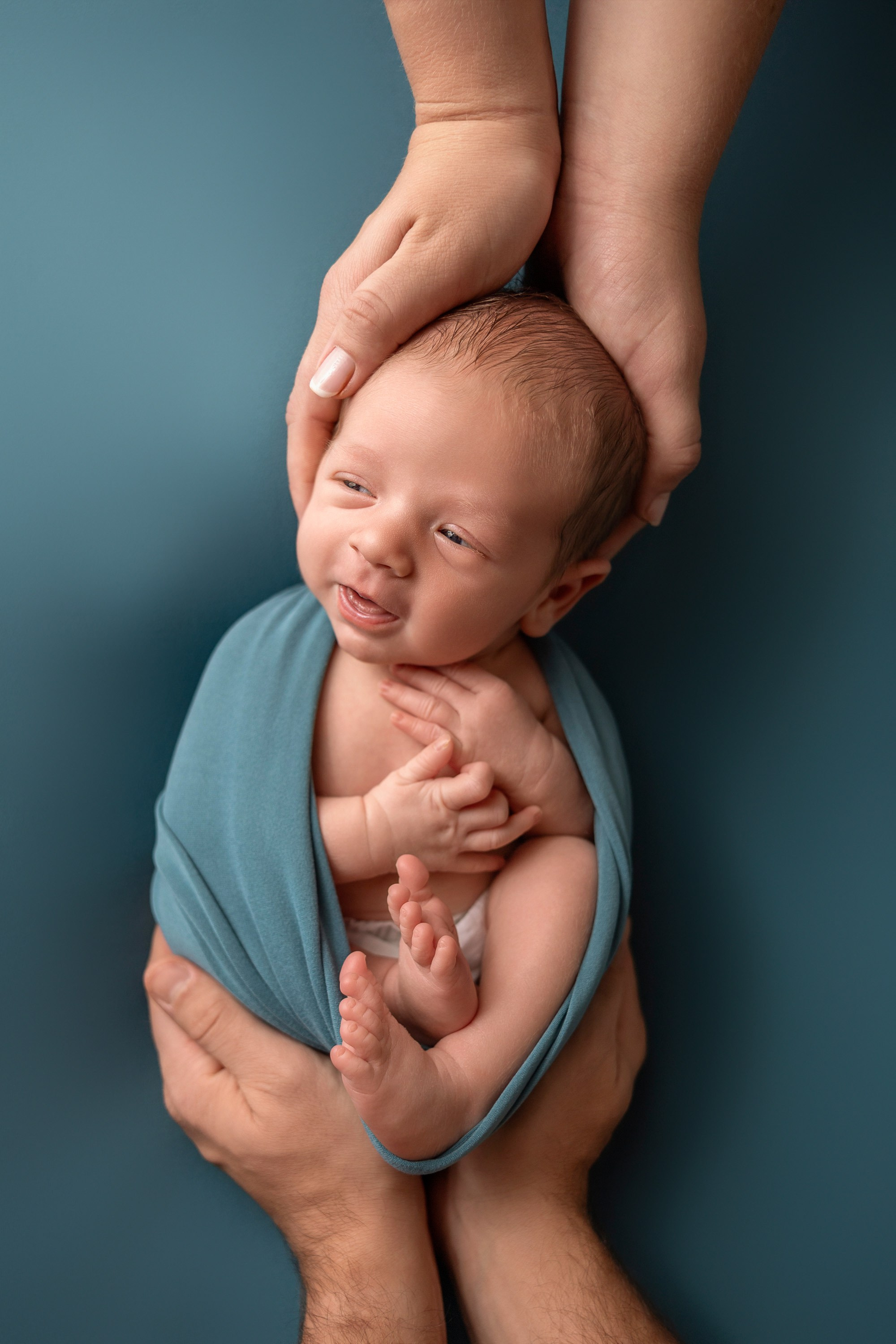 newborn photo with parents hands