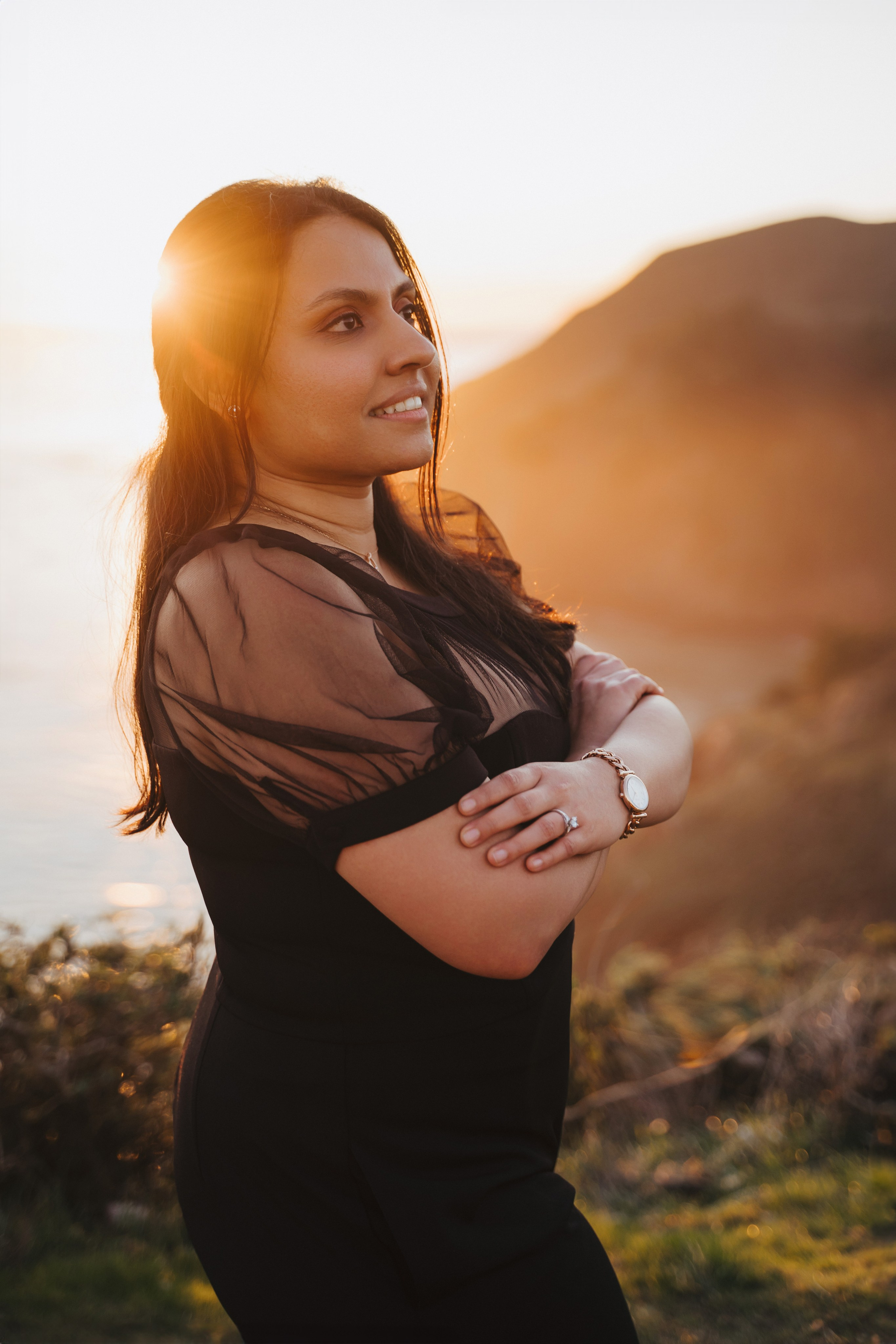 Proposal.  Overlooking the golden San Franisco Bridge sunset with a couple. Photographer Video. 