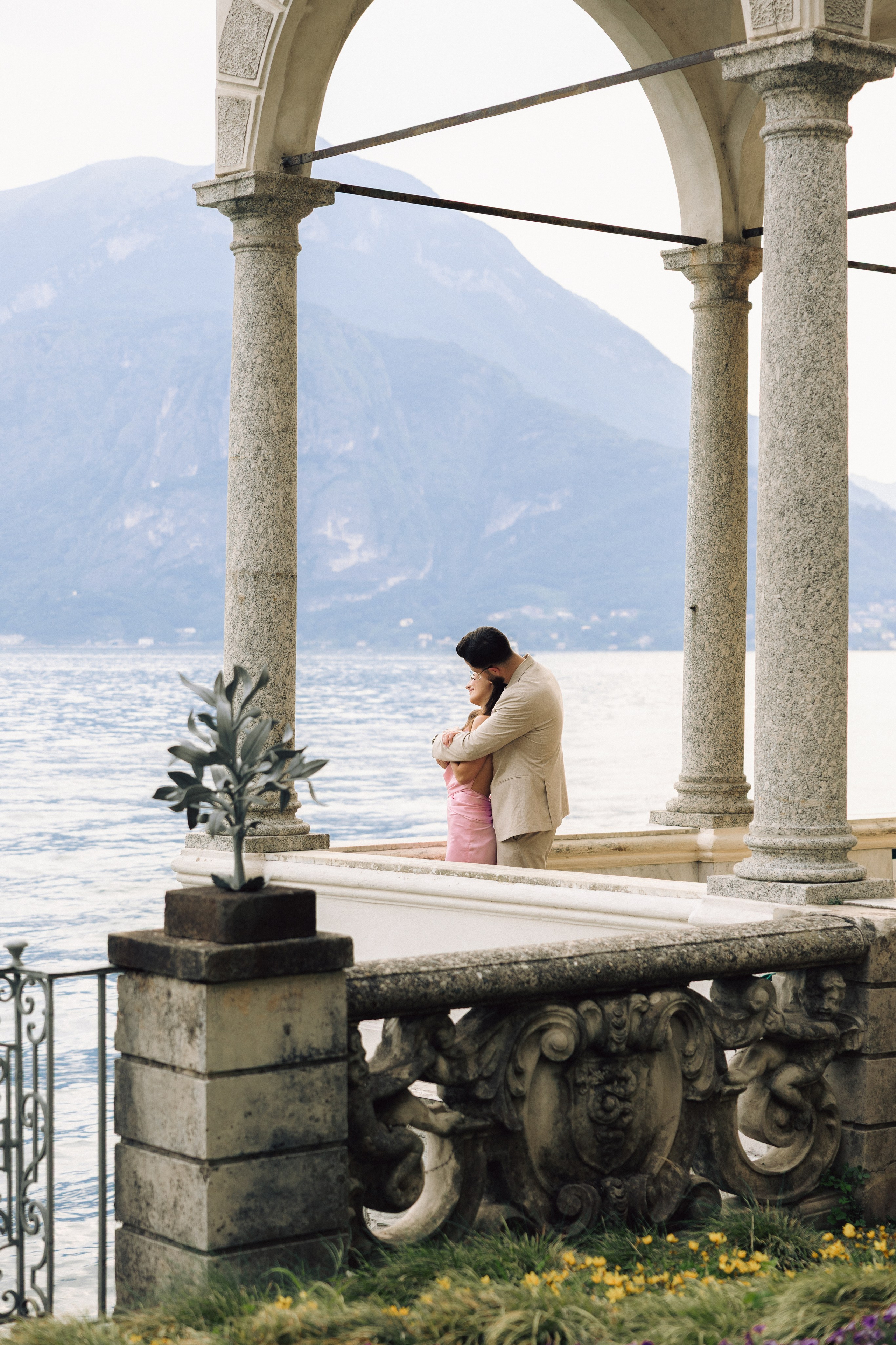 Couple enjoying a quiet romantic moment overlooking Lake Como at Villa Monastero, Italy