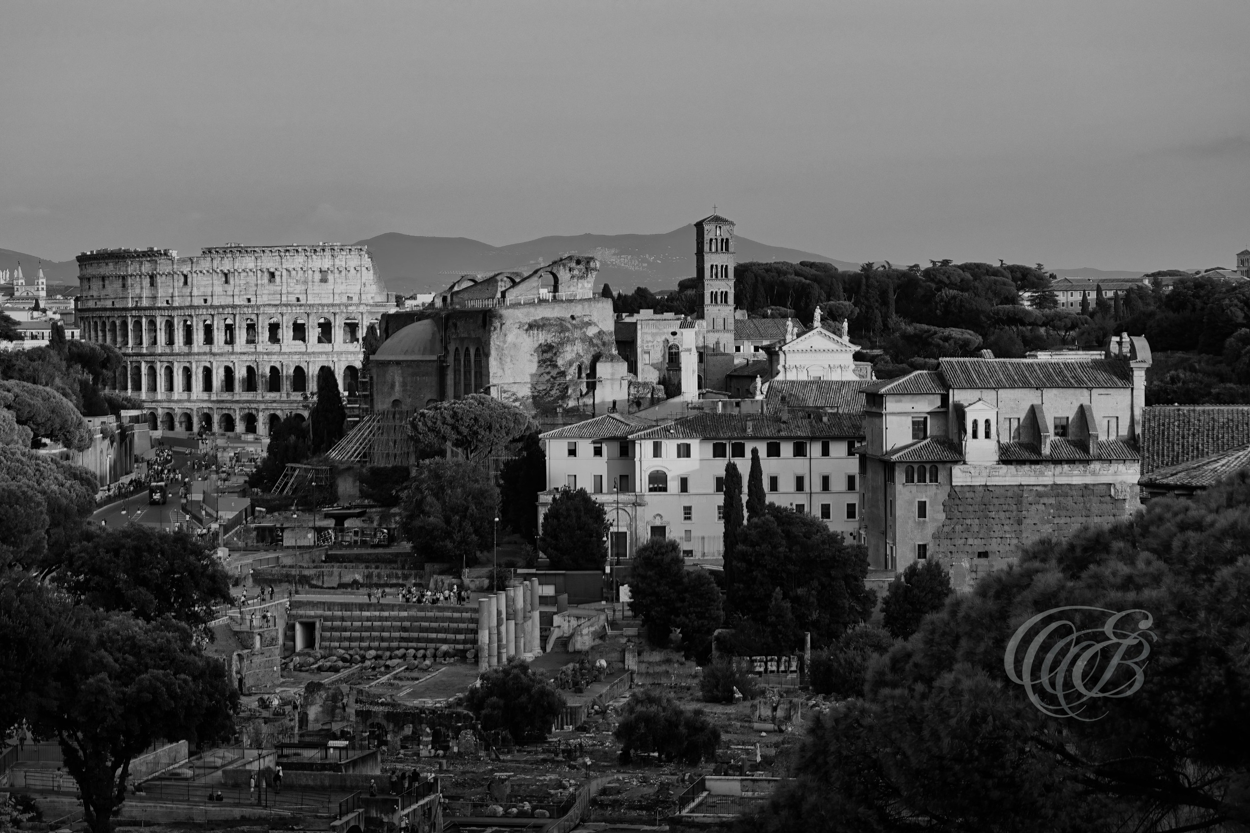 Rome Italy – Colosseum silhouetted against the fading light at sunset, ancient Roman amphitheater rendered in black and white fine art photography. Rome, Italy – photography by Eduardo Bartoli.