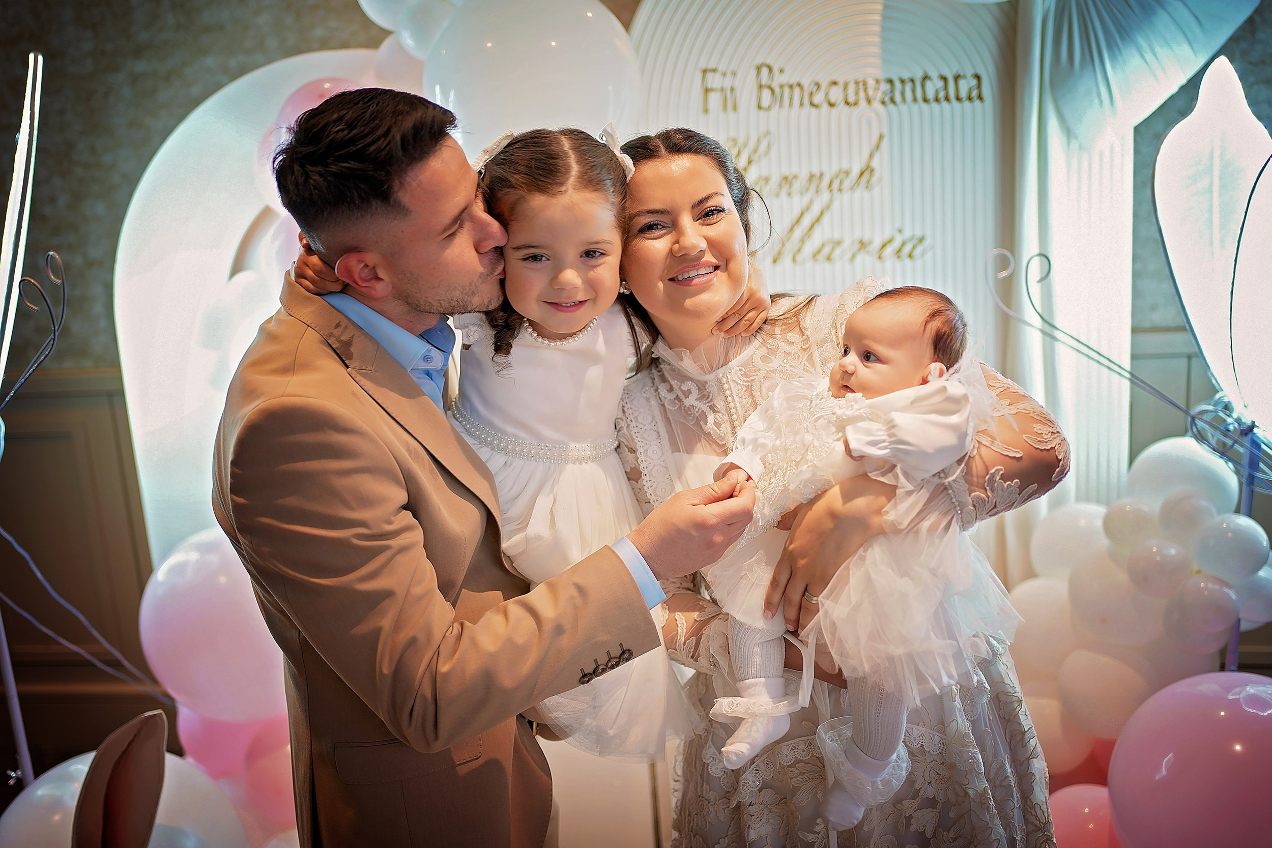 Happy family posing at a professional baptism event.