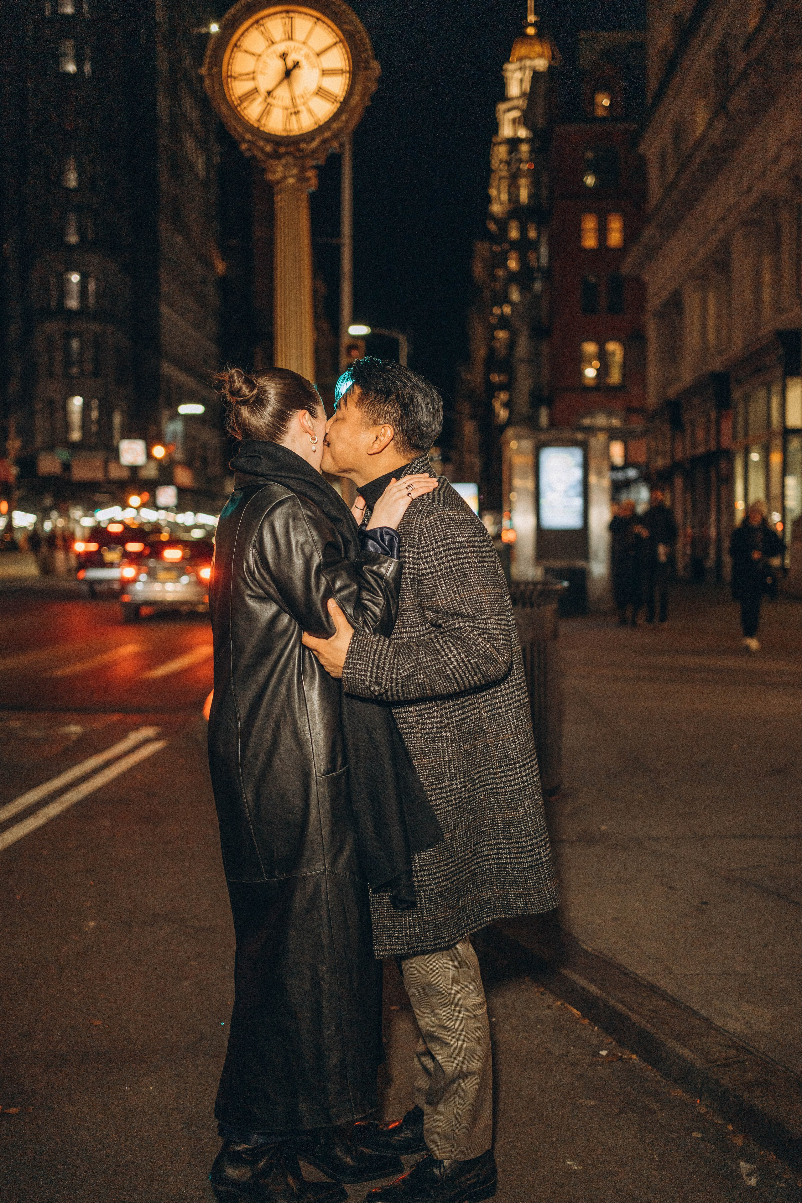 Couple hugging after proposal at Empire State Building.