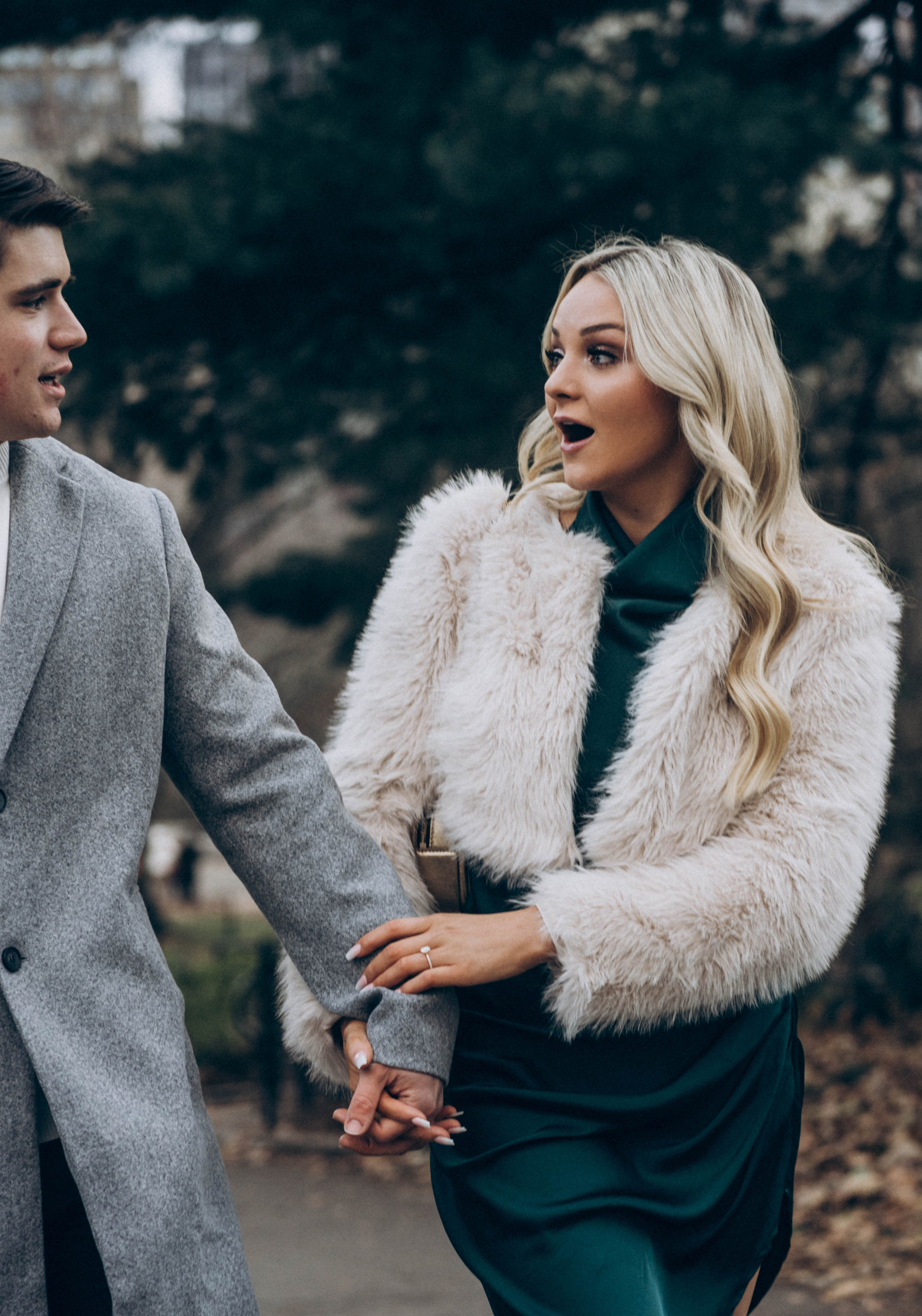 Couple laughing after proposal by Manhattan Bridge.