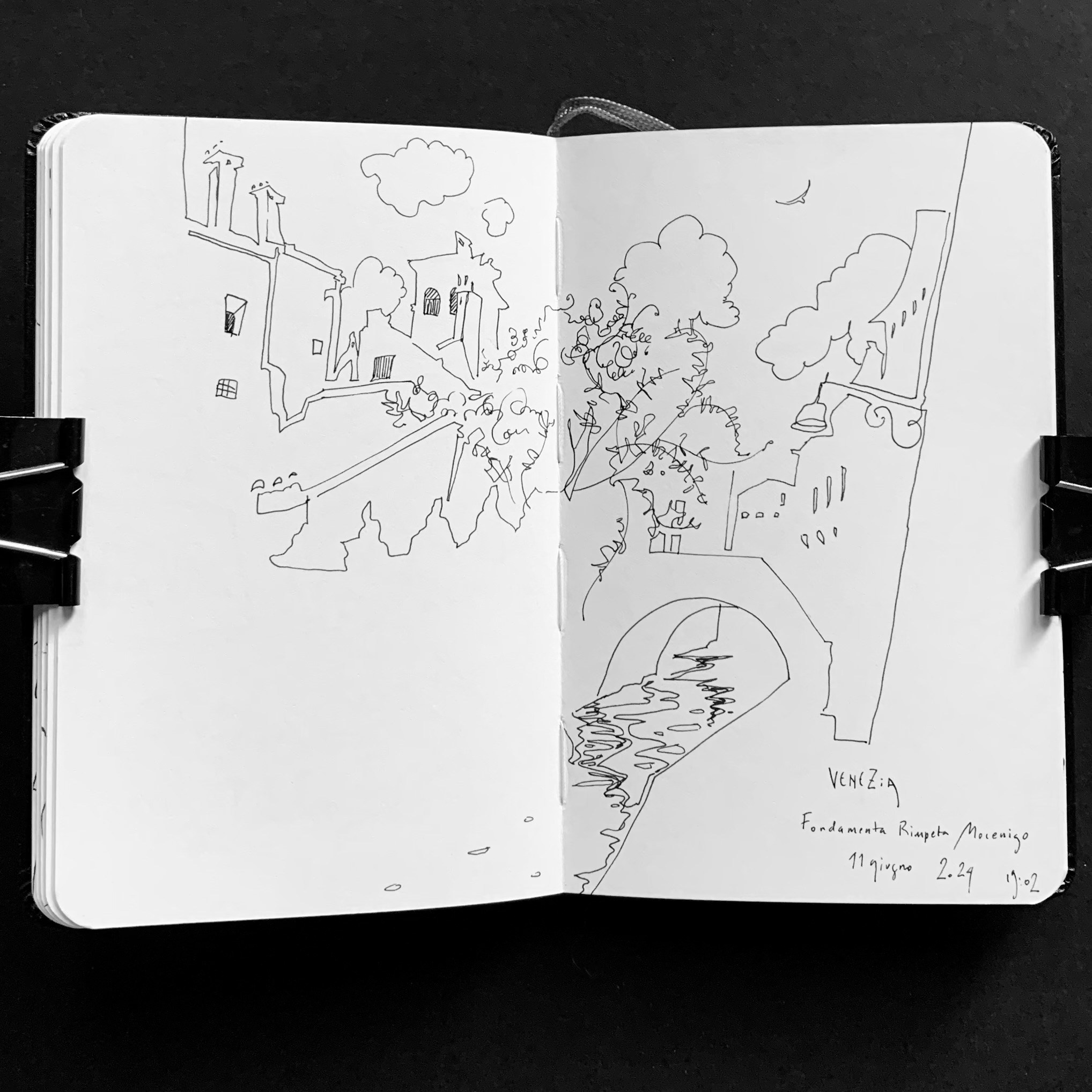 Moleskine notebook with original drawings made in Venice, research on paper for an editorial project by an artist who lives and works in Venice. A spontaneous drawing of a bridge and houses.