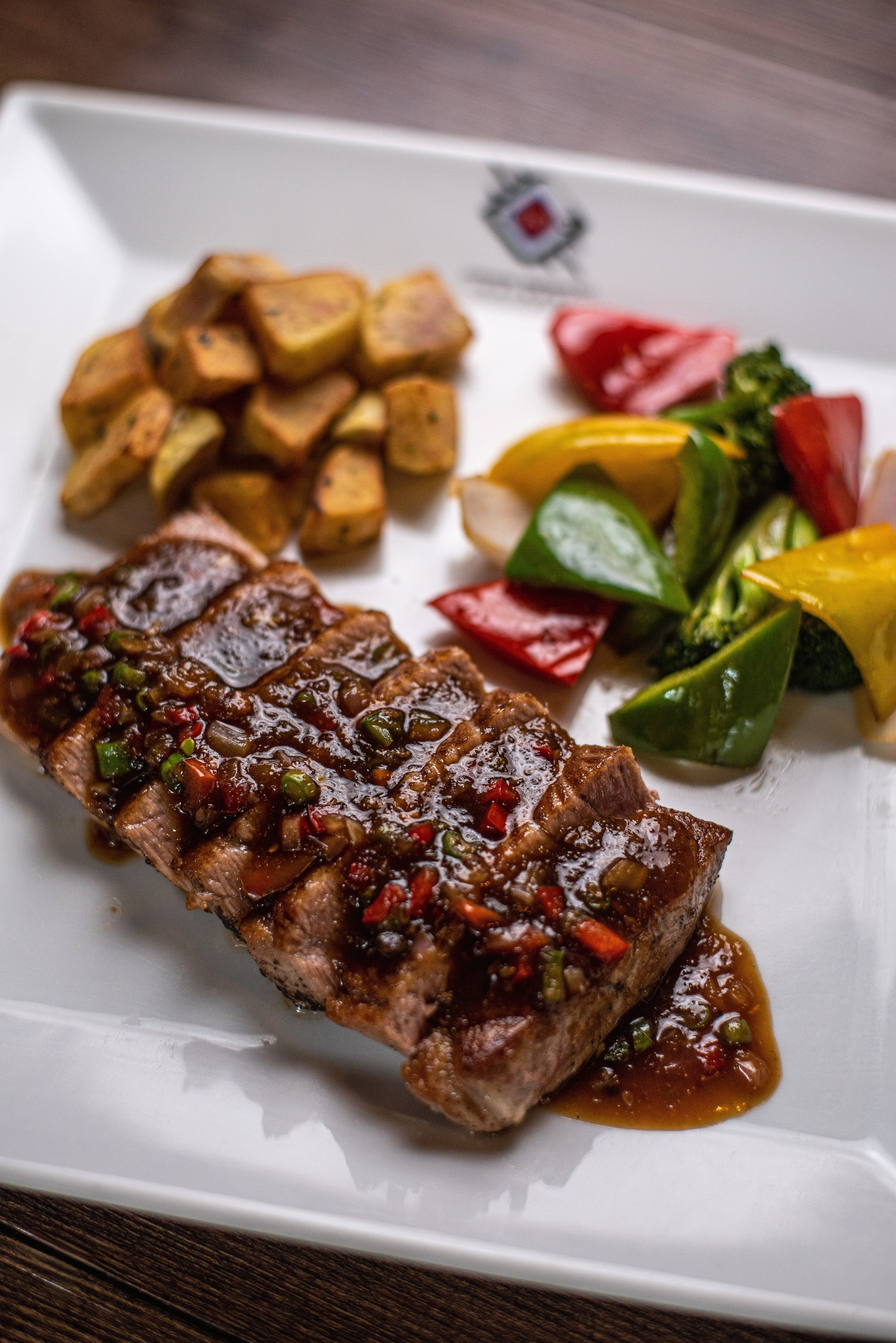 A plate of tuna with assorted vegetables at a Japanese restaurant- food styling