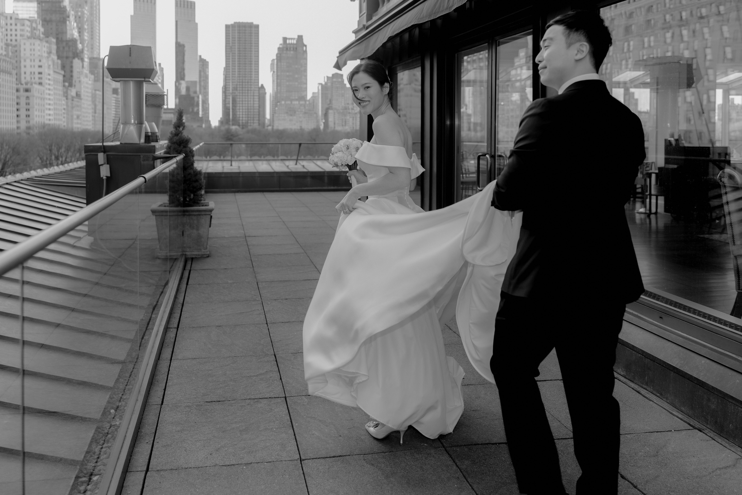 a bride and groom walking down the street