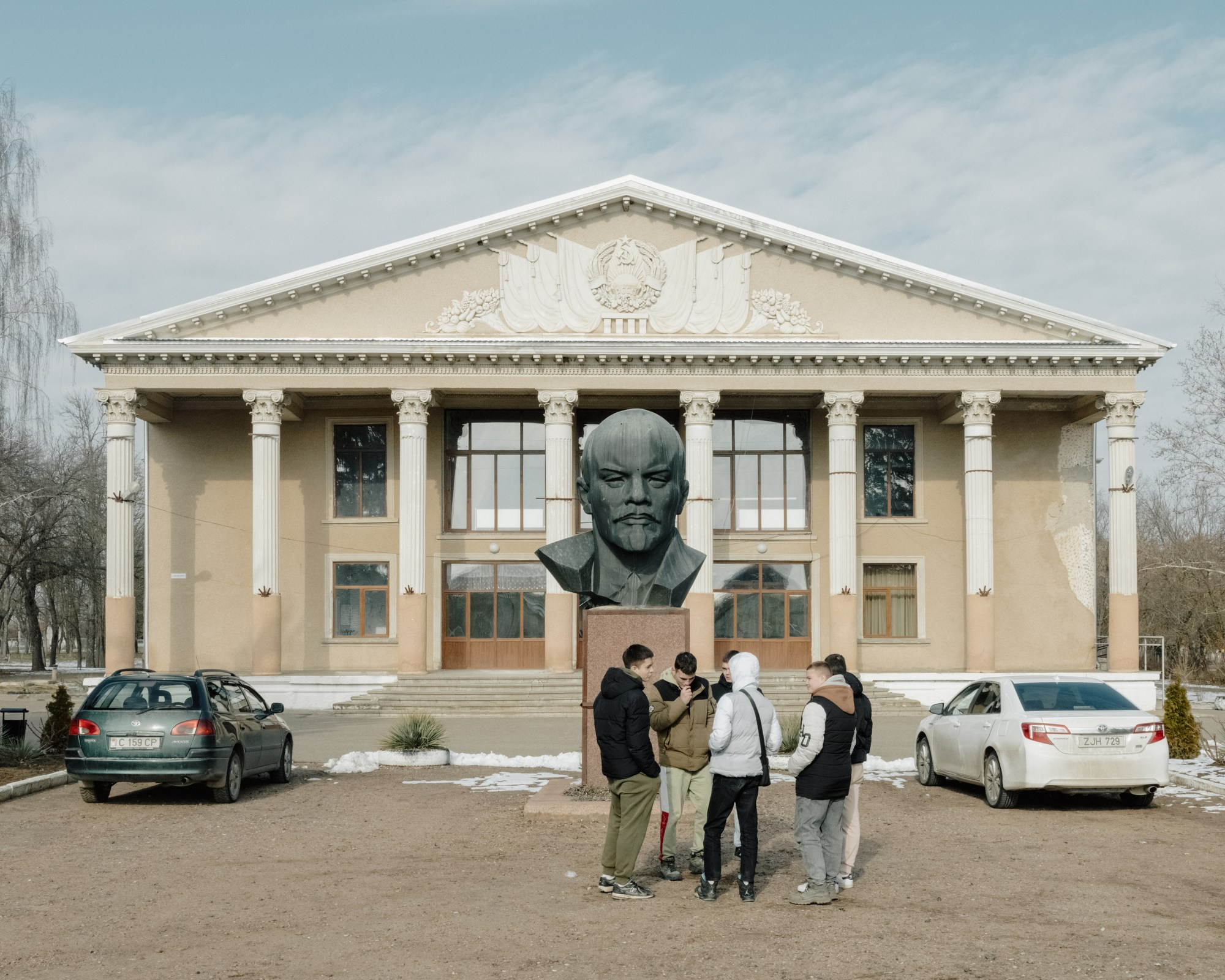 A group of young people talk in front of the House of Culture in Chitcani, a small village in Transnistria. Like many such buildings in the region, this one features a statue of Vladimir Lenin — a common sight in Transnistria, where Houses of Culture served as hubs of Soviet ideology and culture. The statues reflect the region’s enduring ties to its Soviet past and its political alignment with Russia.
