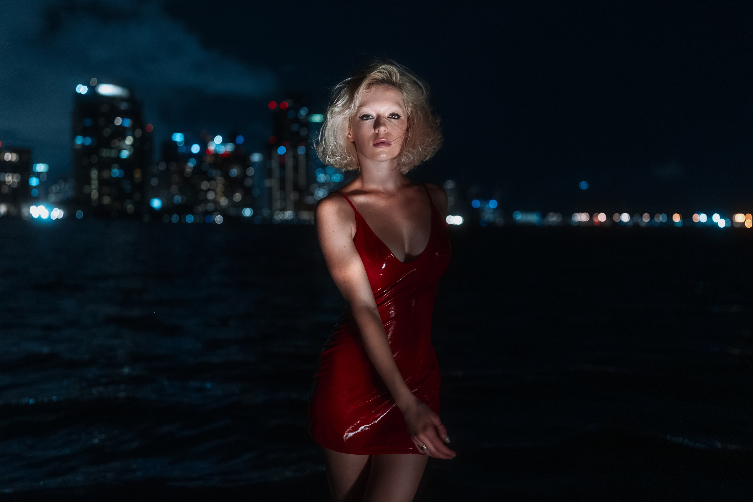 The model walks slowly along the shoreline. The frame suggests freedom.