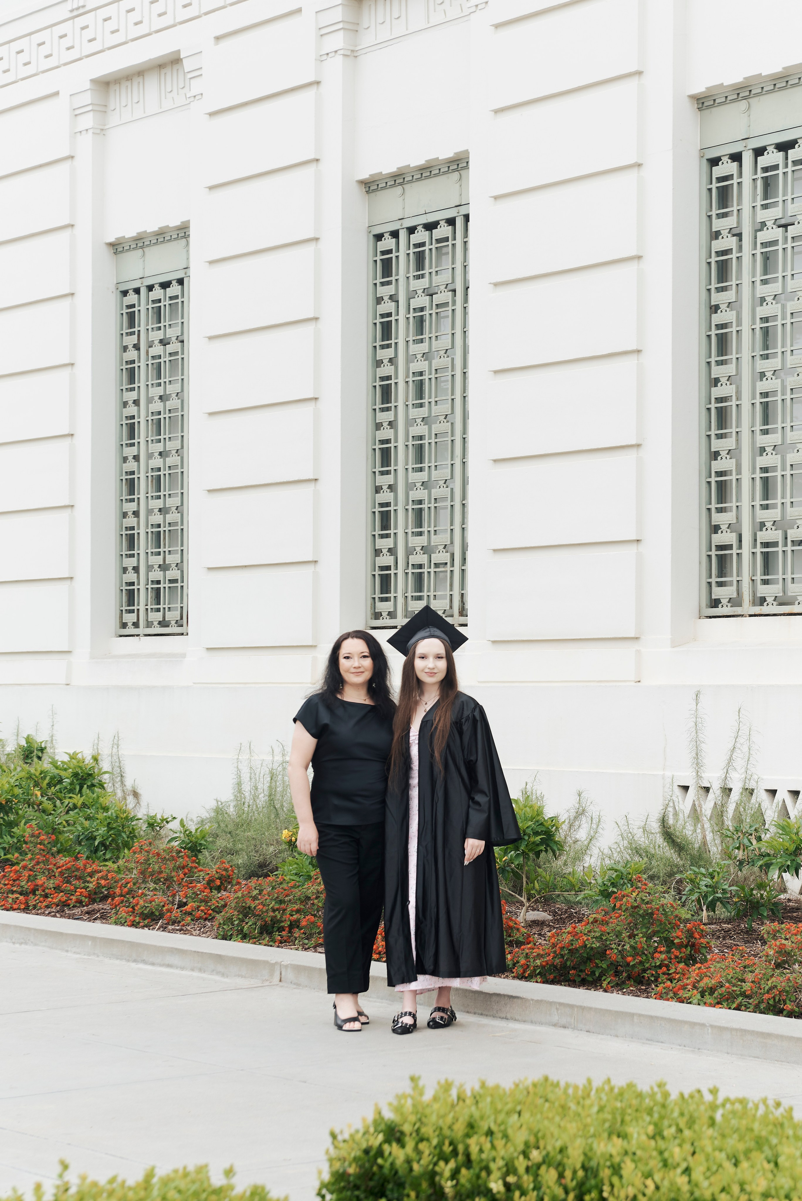 Graduation photo with a student and their pet in a Los Angeles park