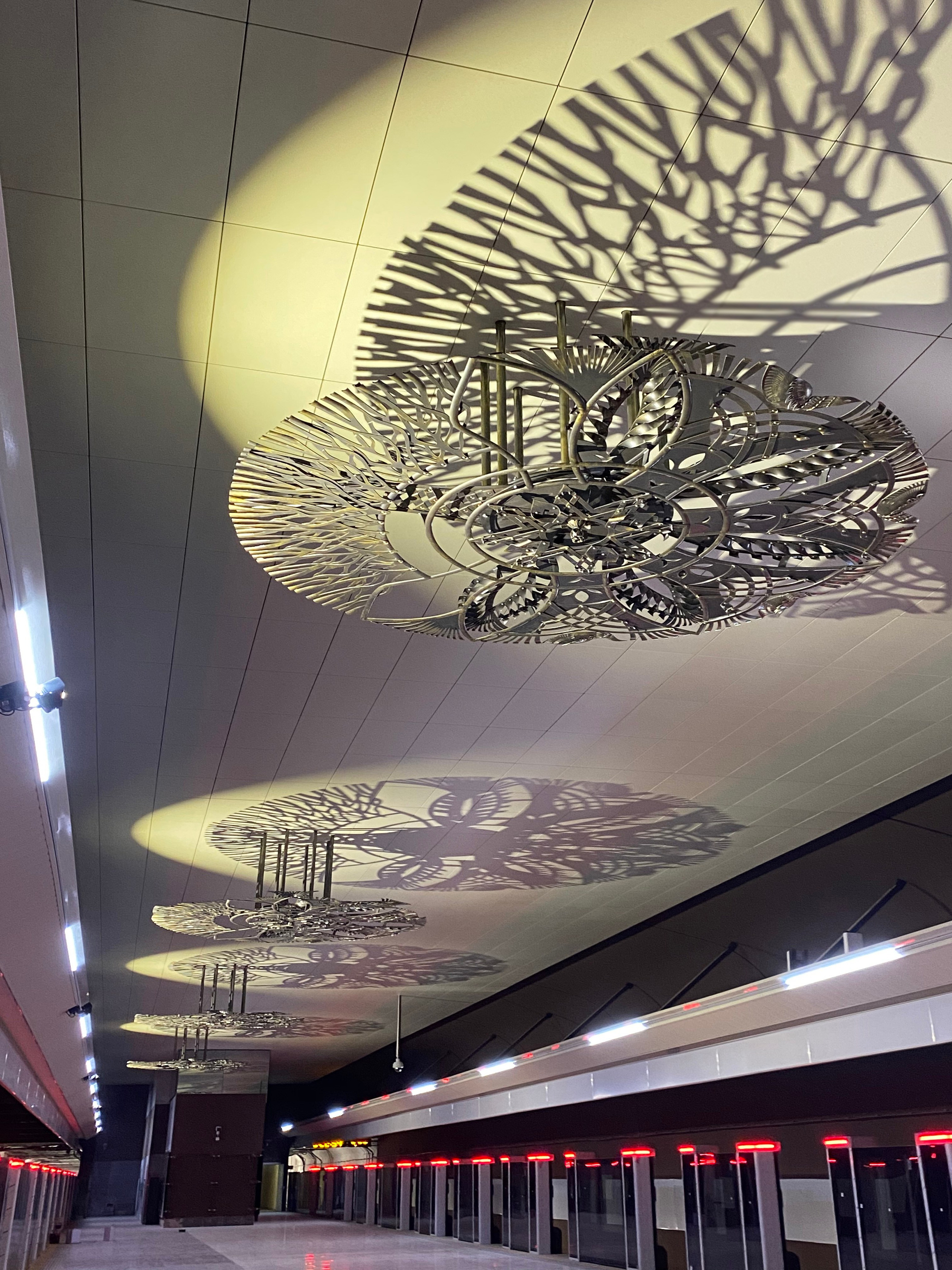 Минское Метро. Станция «Ковальская слобода». 2019-2020 «КАВАЛЬСКIЯ ВЫЦIНАНКI» кованые подвесные светотеневые композиции, декоративные элементы. Сталь, художественная ковка, лазерная резка, сварка. Художники Мария Тарлецкая, Павел Войницкий, Архитекторы Владимир Телепнёв, Ольга Телепнёва, Анна Кузмич. По мотивам произведений Елизаветы Червонцевой и Молодечненской школы вытинанки. Перонн. Перонный зал.