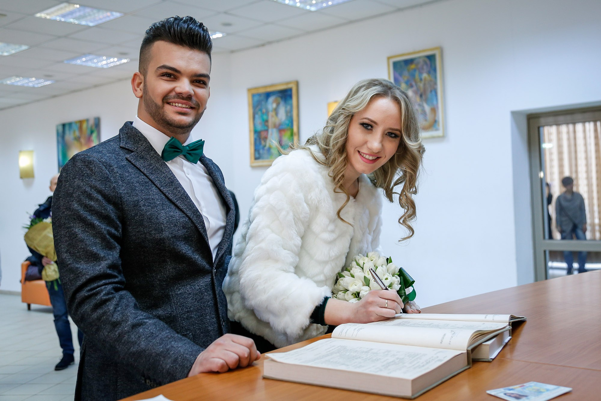 Smiling bride signing the marriage certificate at the town hall, a memorable moment captured by the civil ceremony photographer.