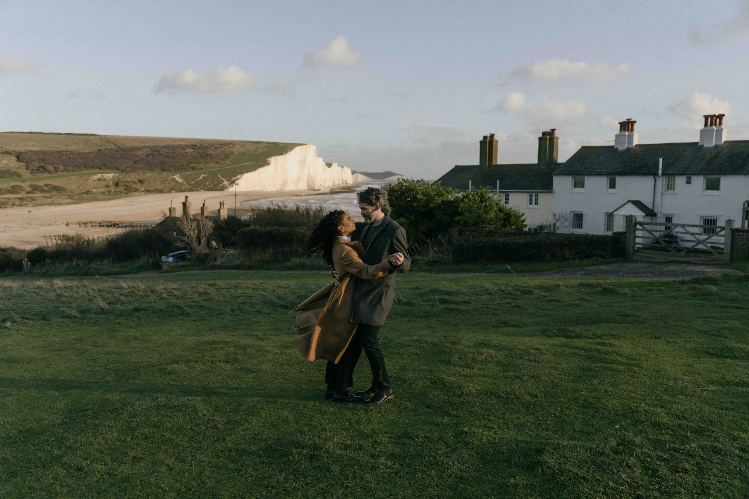 wide landscape couple seven sisters cliffs england engagement session