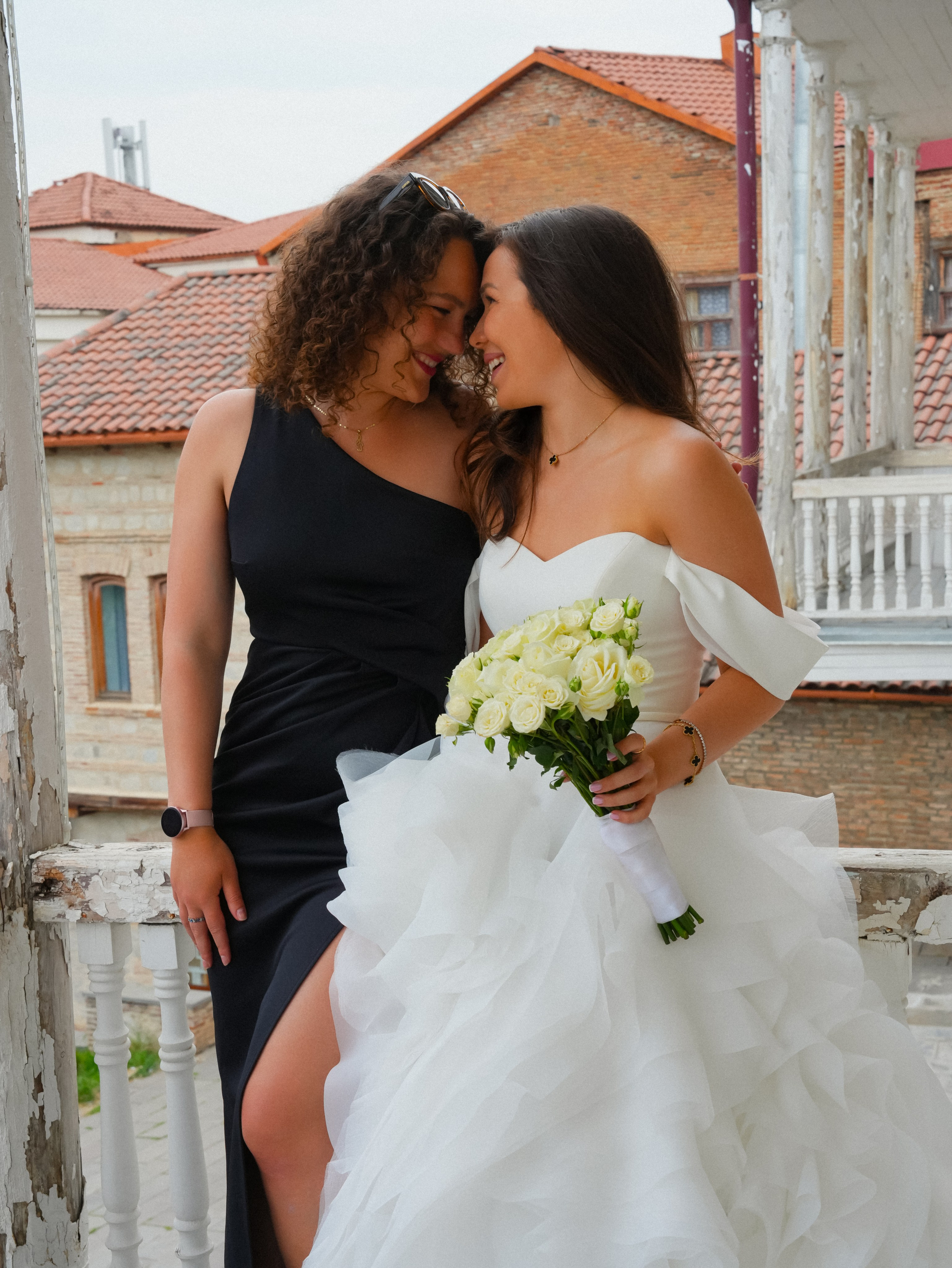 Bride with friend on balcony in Sighnaghi