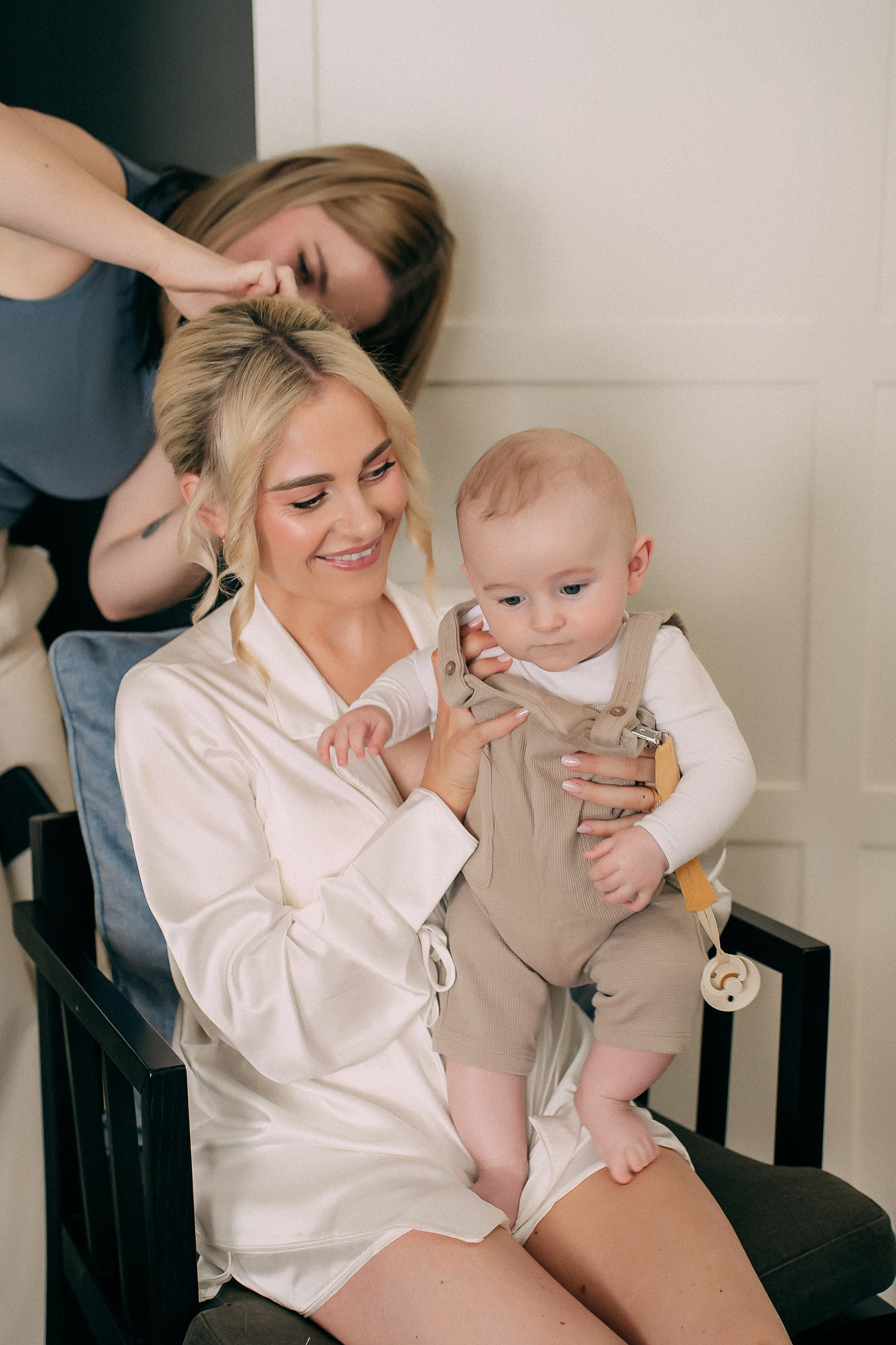 Bride getting ready with her baby before an intimate Lake Como elopement in Italy