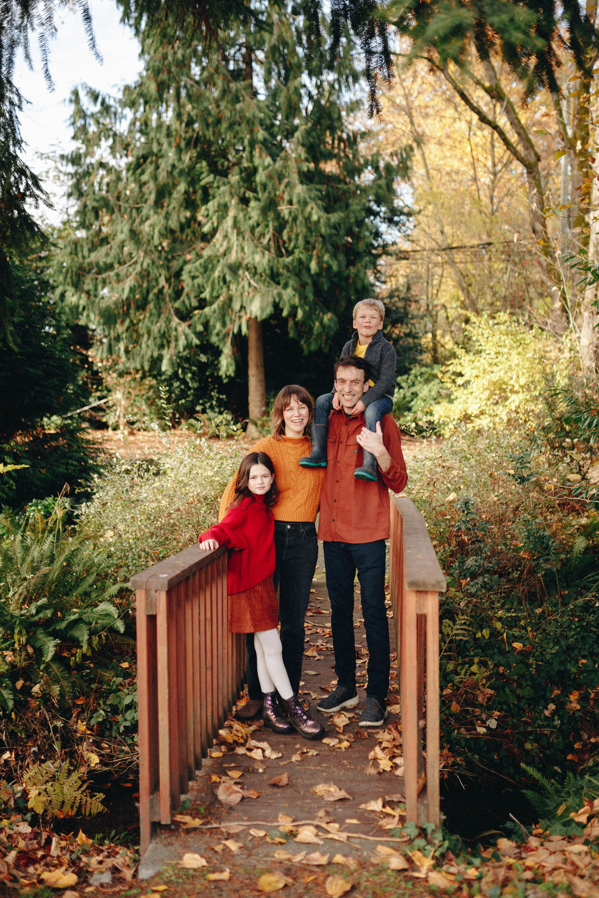 Couple standing on wooden bridge, autumn engagement shoot