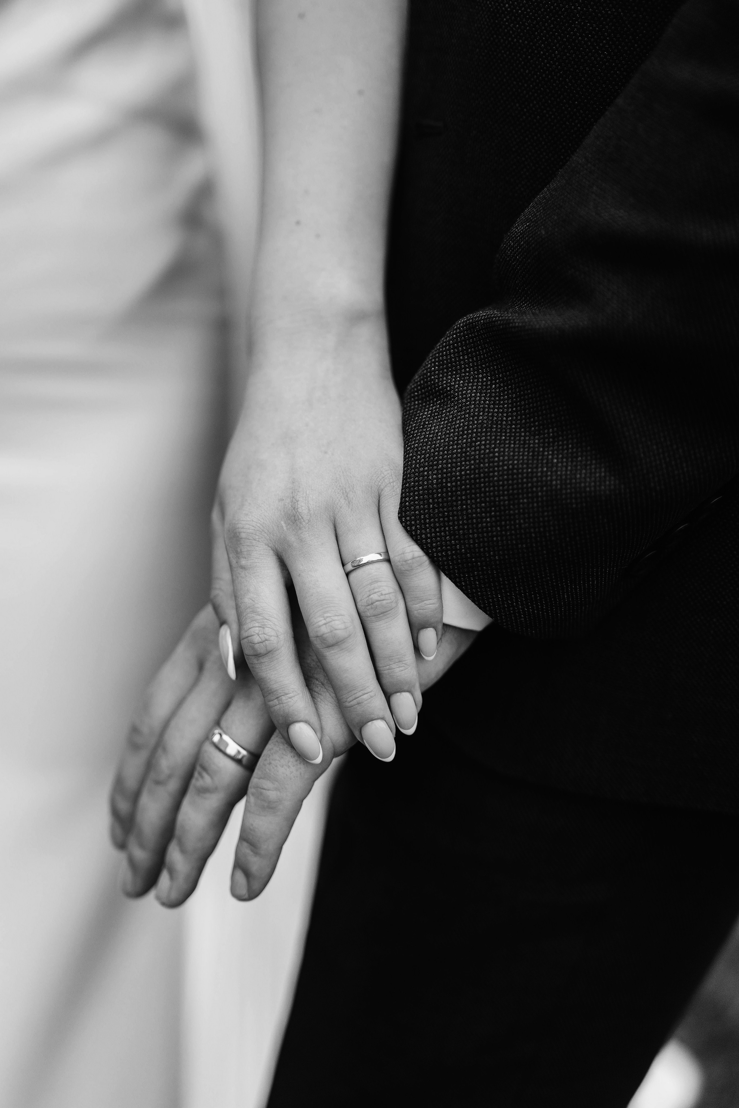 black and white photo of bride's and groom's hands together