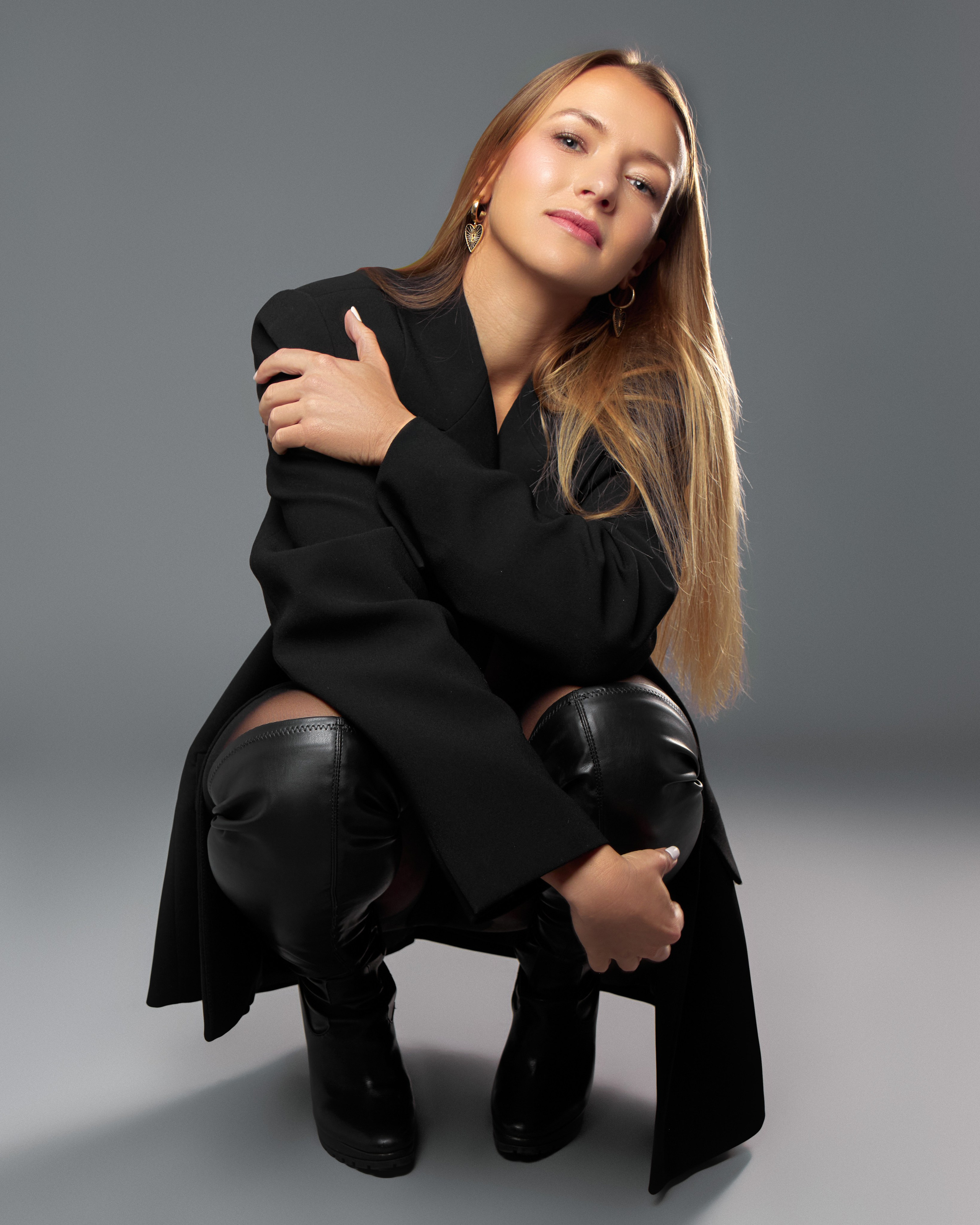 Utah empowerment photoshoot, bold studio portrait of woman in black jacket and boots at Shtatolkina Studio